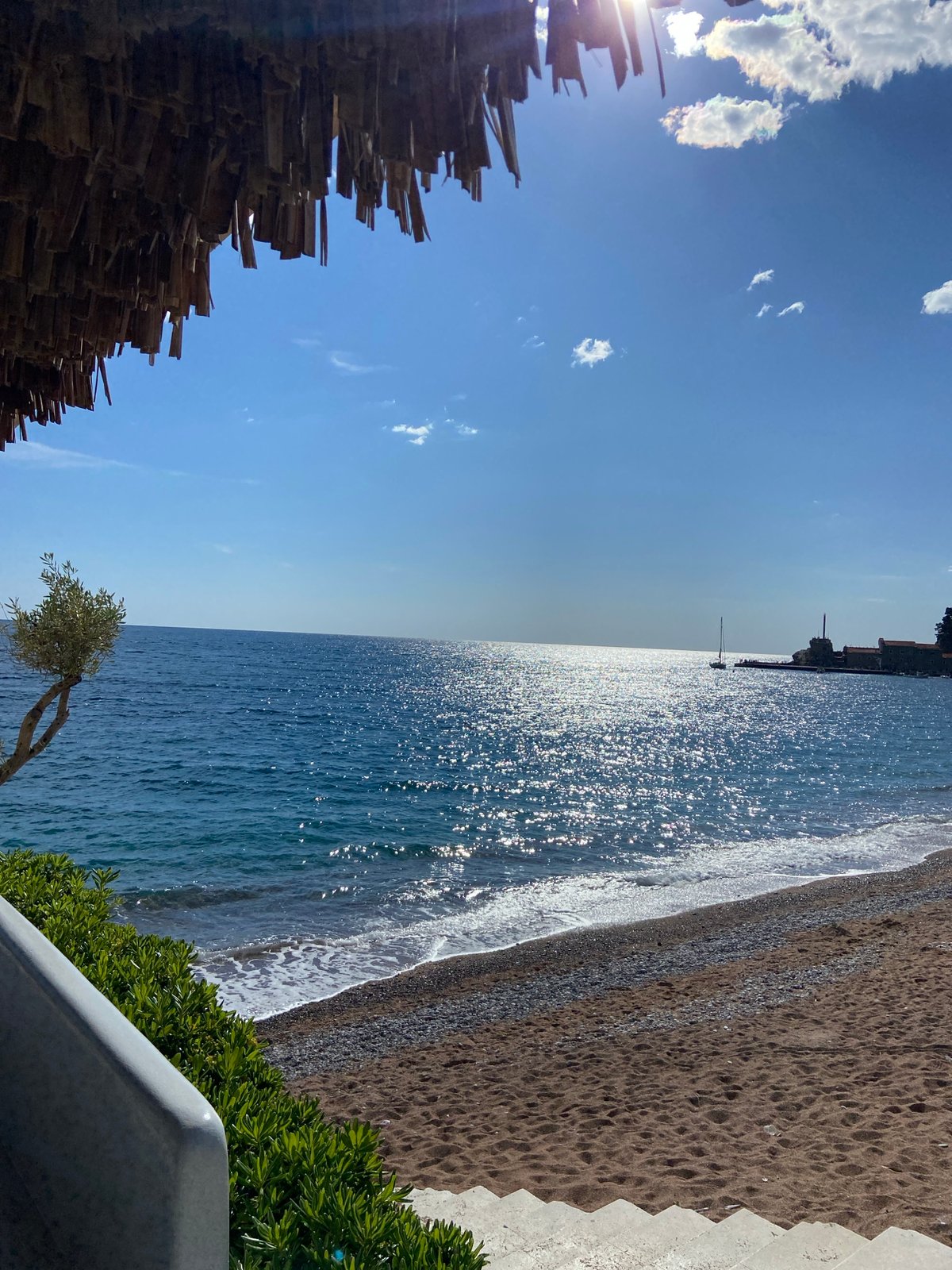 Tourist captures sunny Petrovac beach views and gelato shop visit