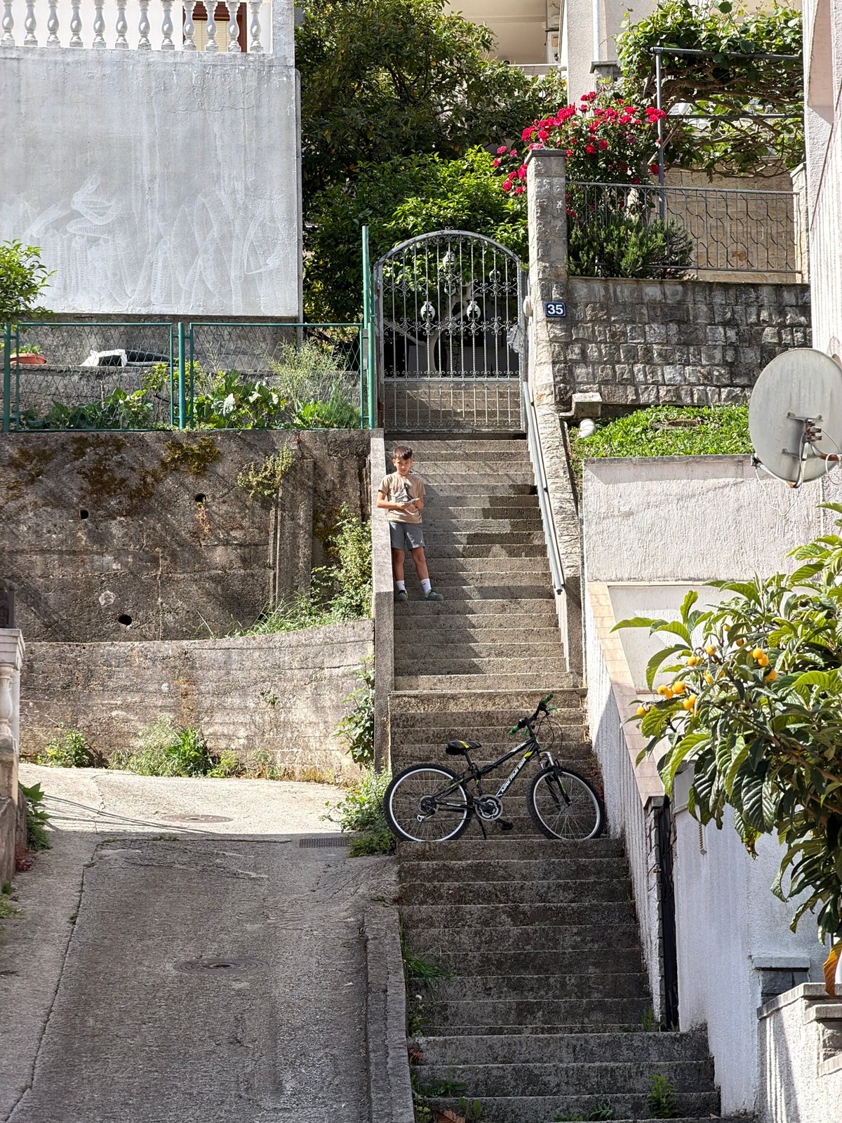 Person lying on concrete stairs in Budva, Montenegro