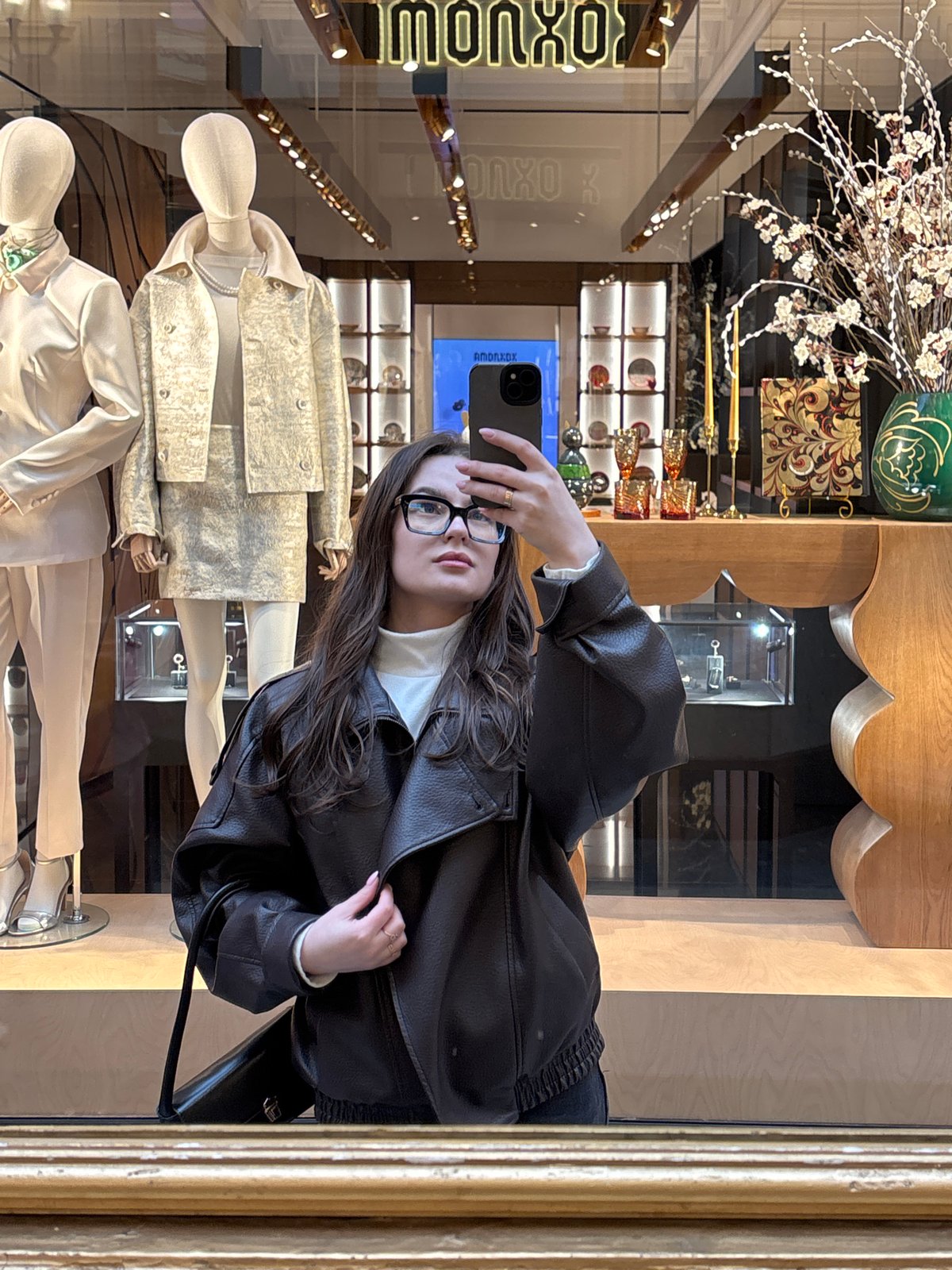 Woman takes selfies during shopping trip at Moscow's GUM