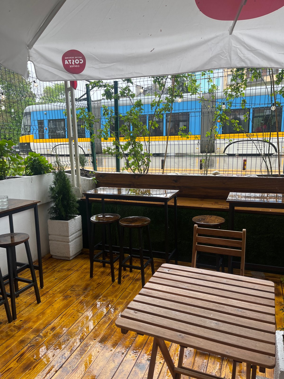 Wet wooden terrace observed at Sofia cafe Thursday morning