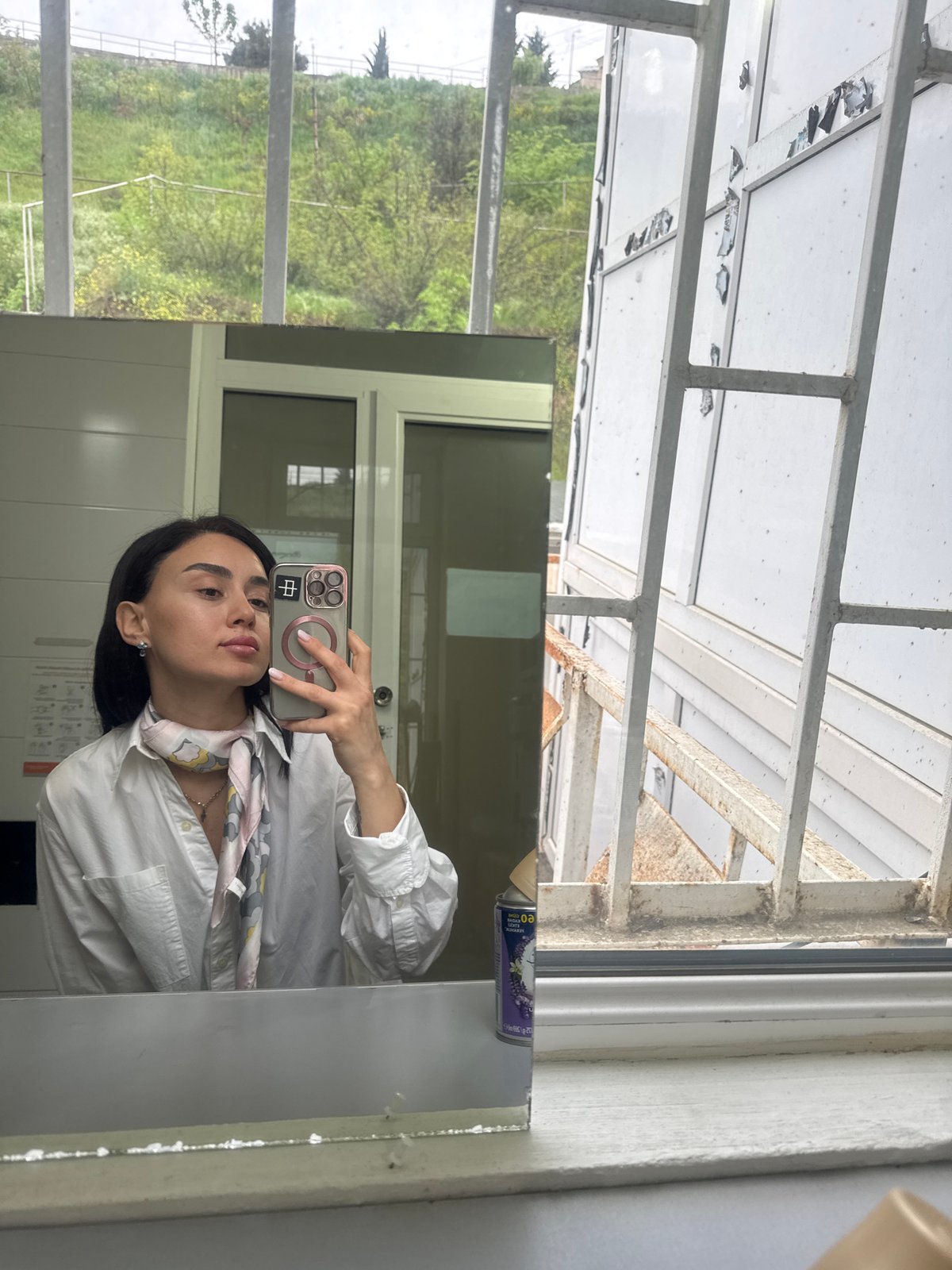 Woman documents morning routine in Tbilisi office setting