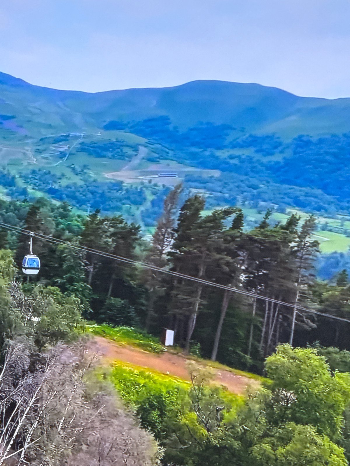 Cable car journey through mountain resort documented by traveler