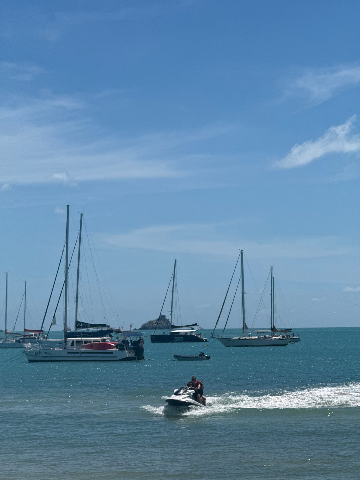 Jet skis and beach gear on a calm Choeng Mon morning