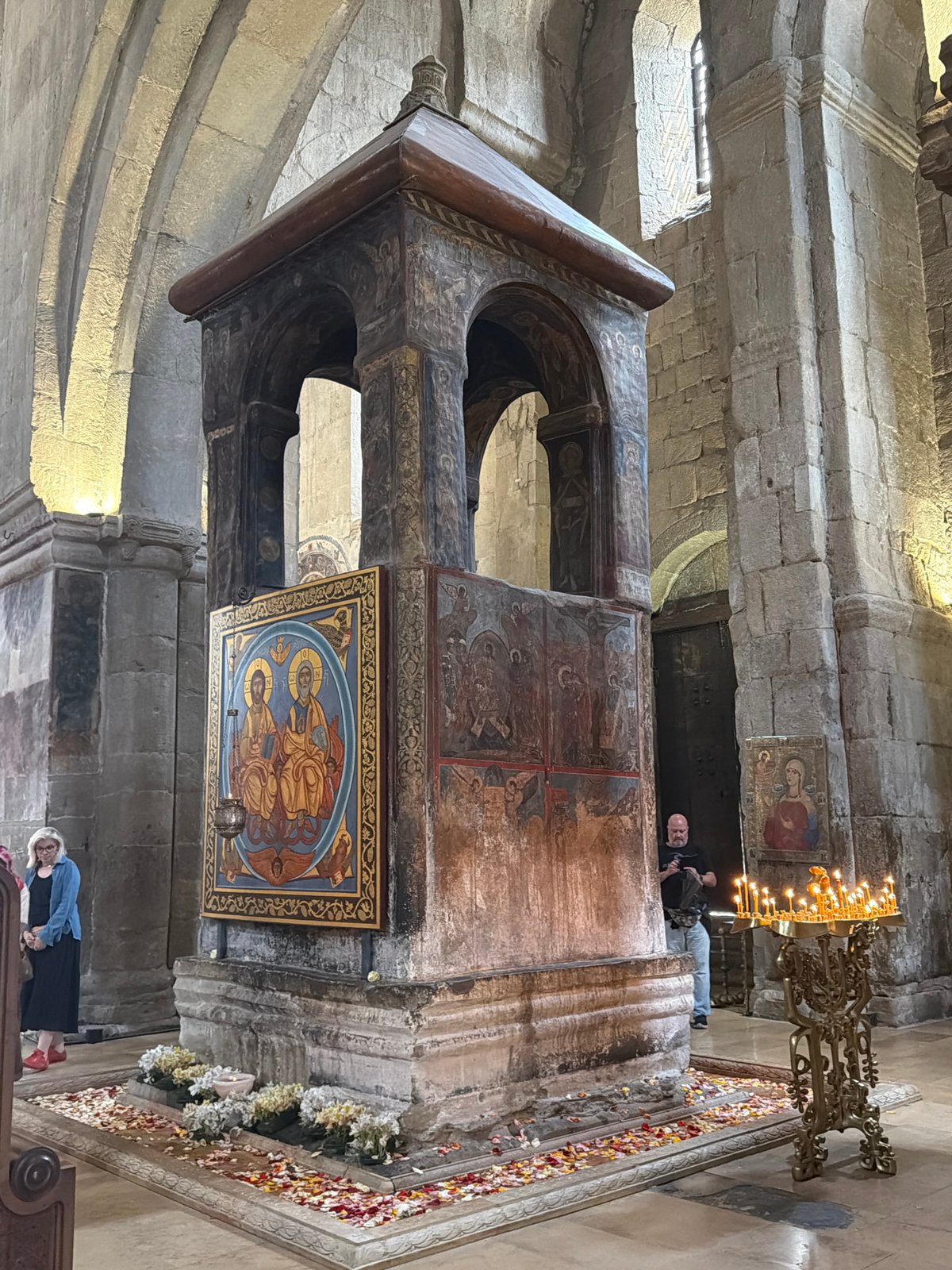 Visitor documents historic cathedral interiors in Mtskheta, Georgia