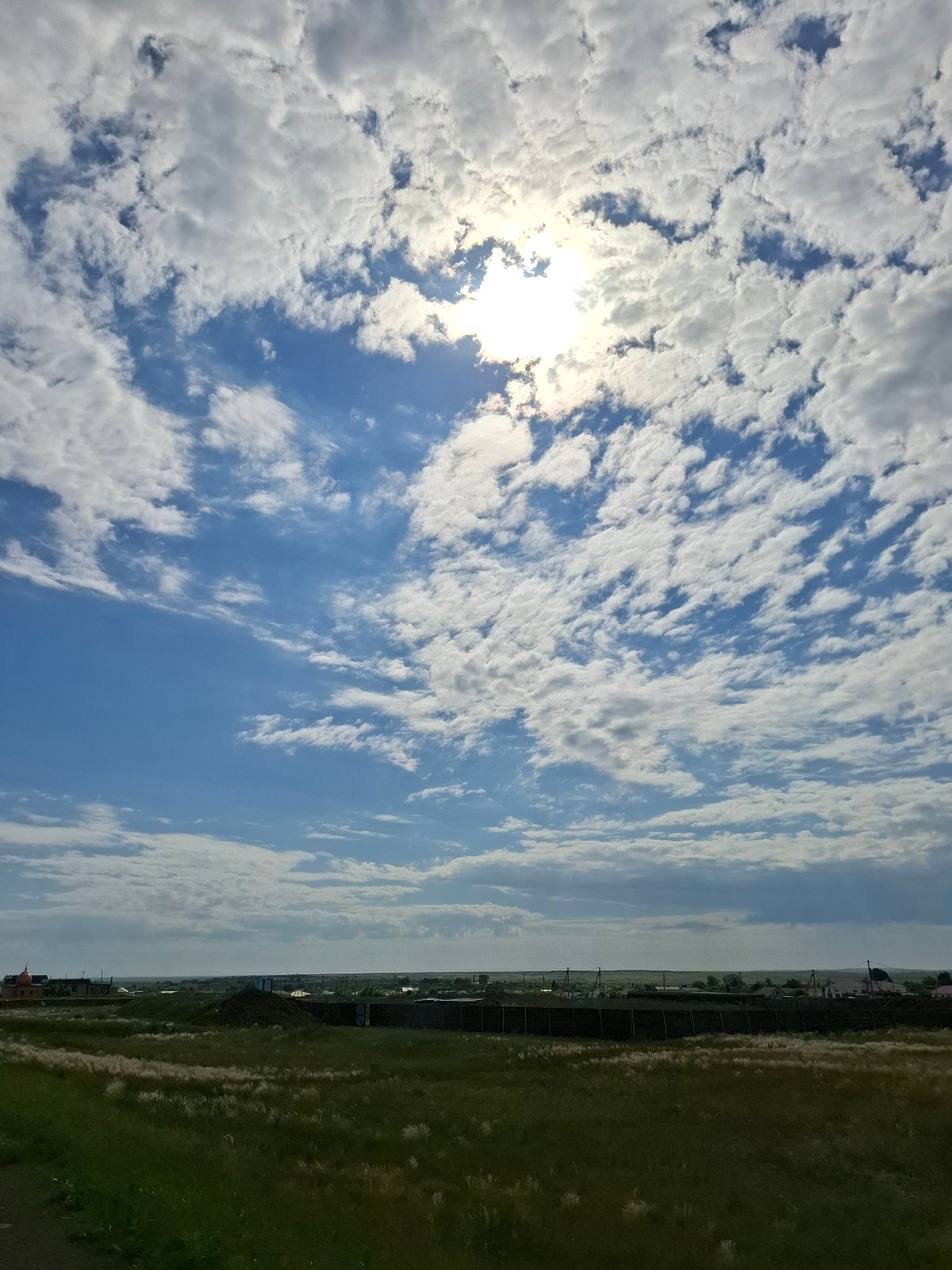Morning sunlight breaks through clouds over Kazakhstan grasslands