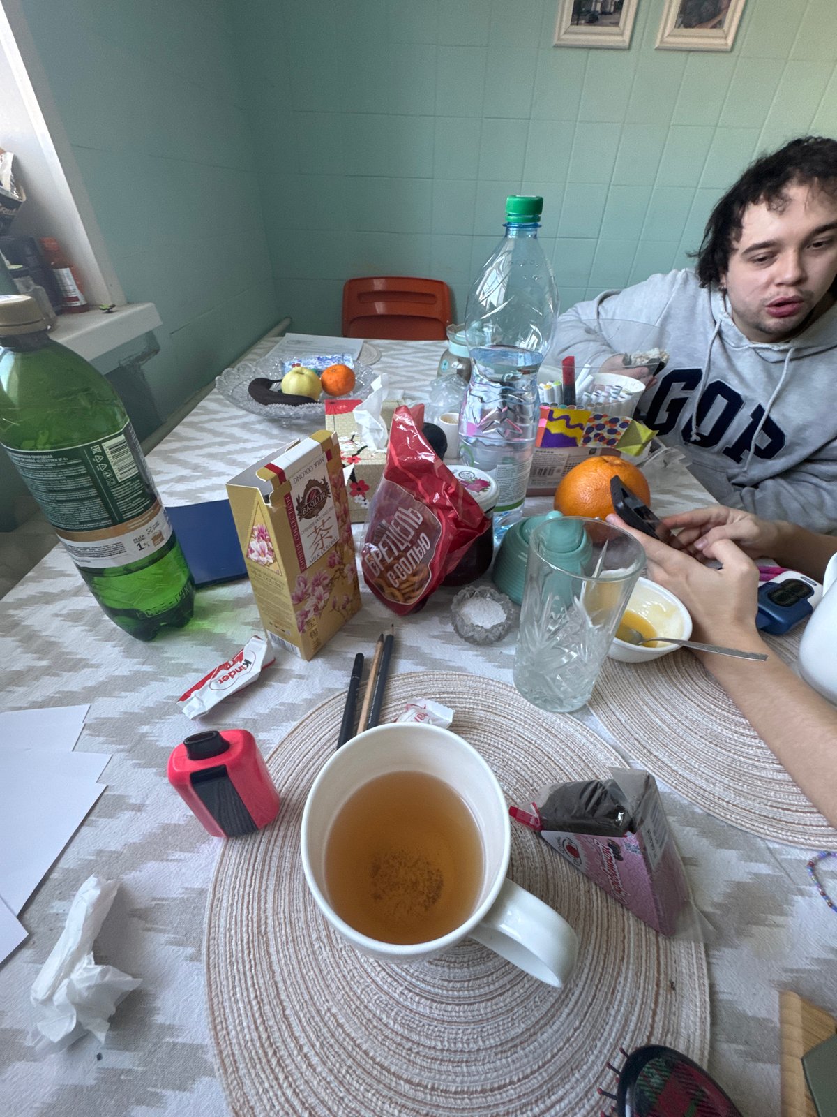 Cluttered table scene documented in Moscow home