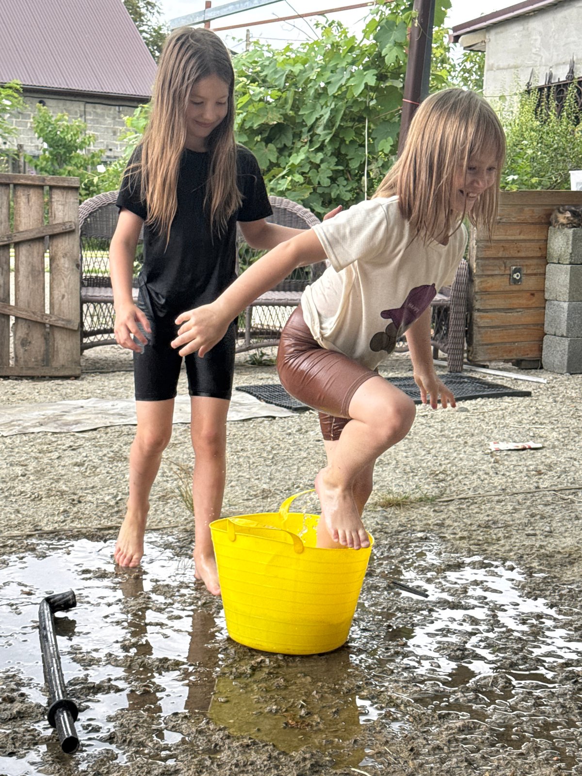 Summer water play around a yellow bucket in Zassovskaya