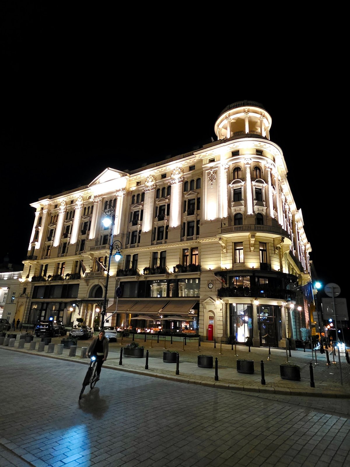 Warsaw's historic center at dusk, classical architecture glowing at night