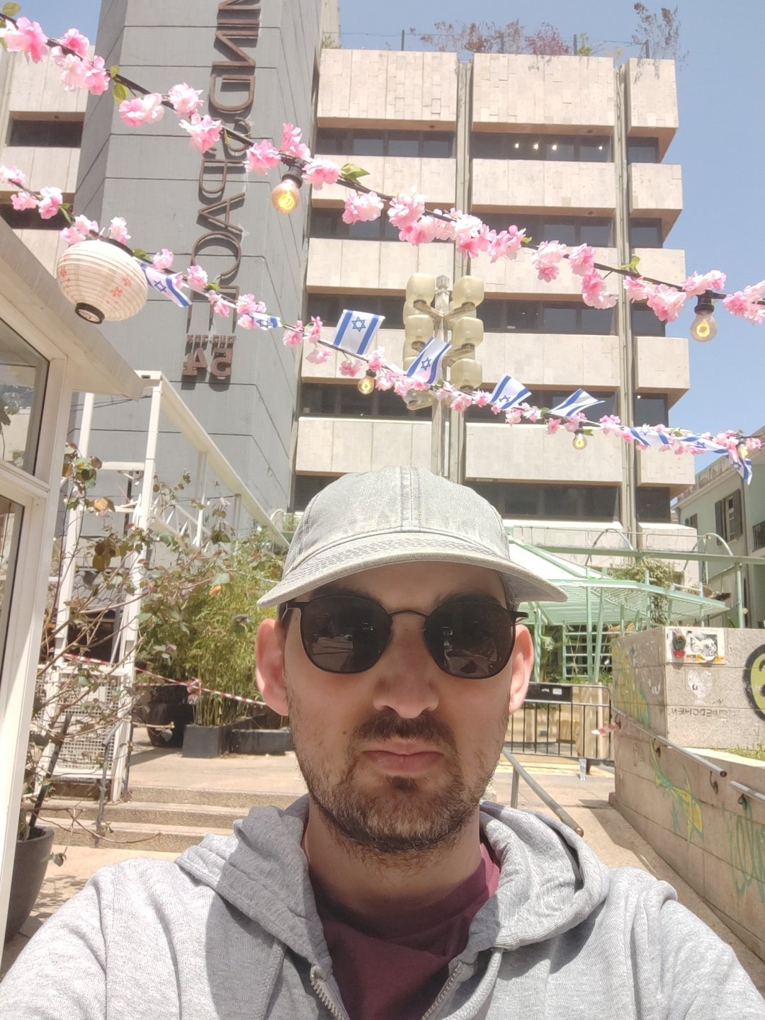 Man takes selfie near MINDSPACE building in Tel Aviv