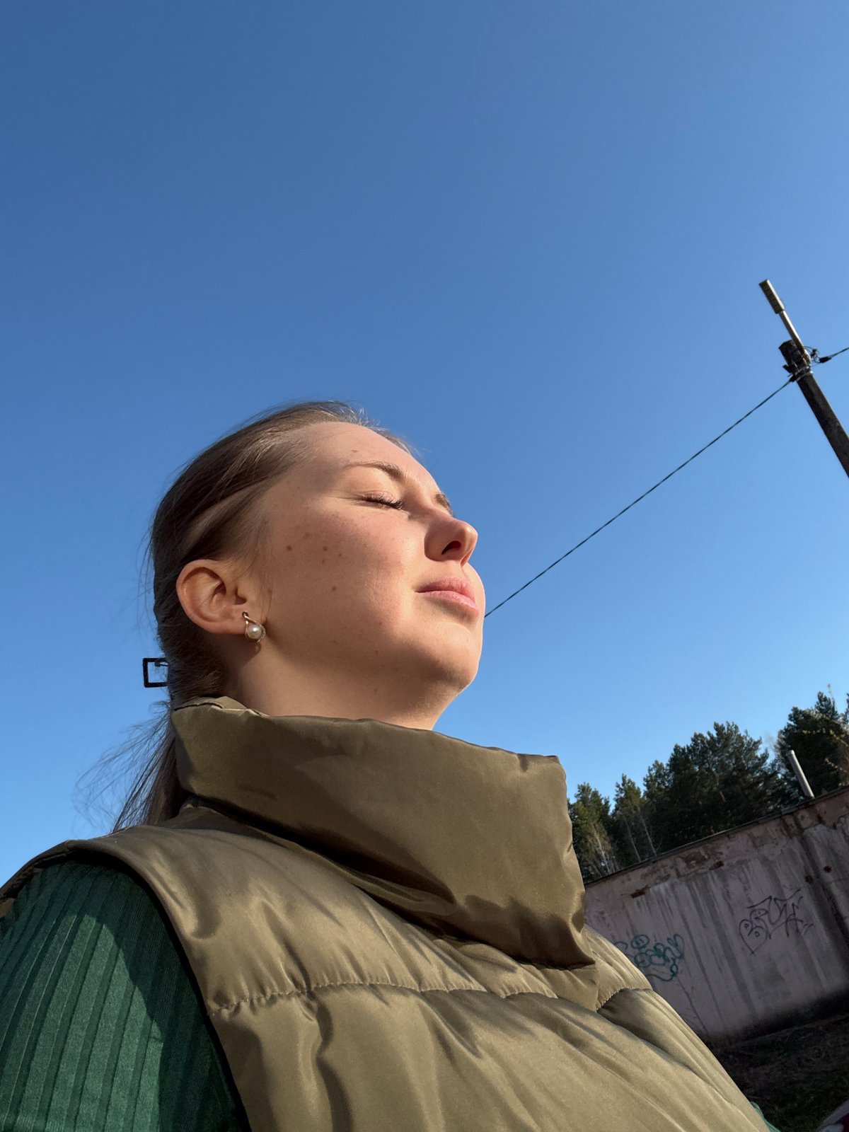 Woman documents spring afternoon stroll through urban park setting