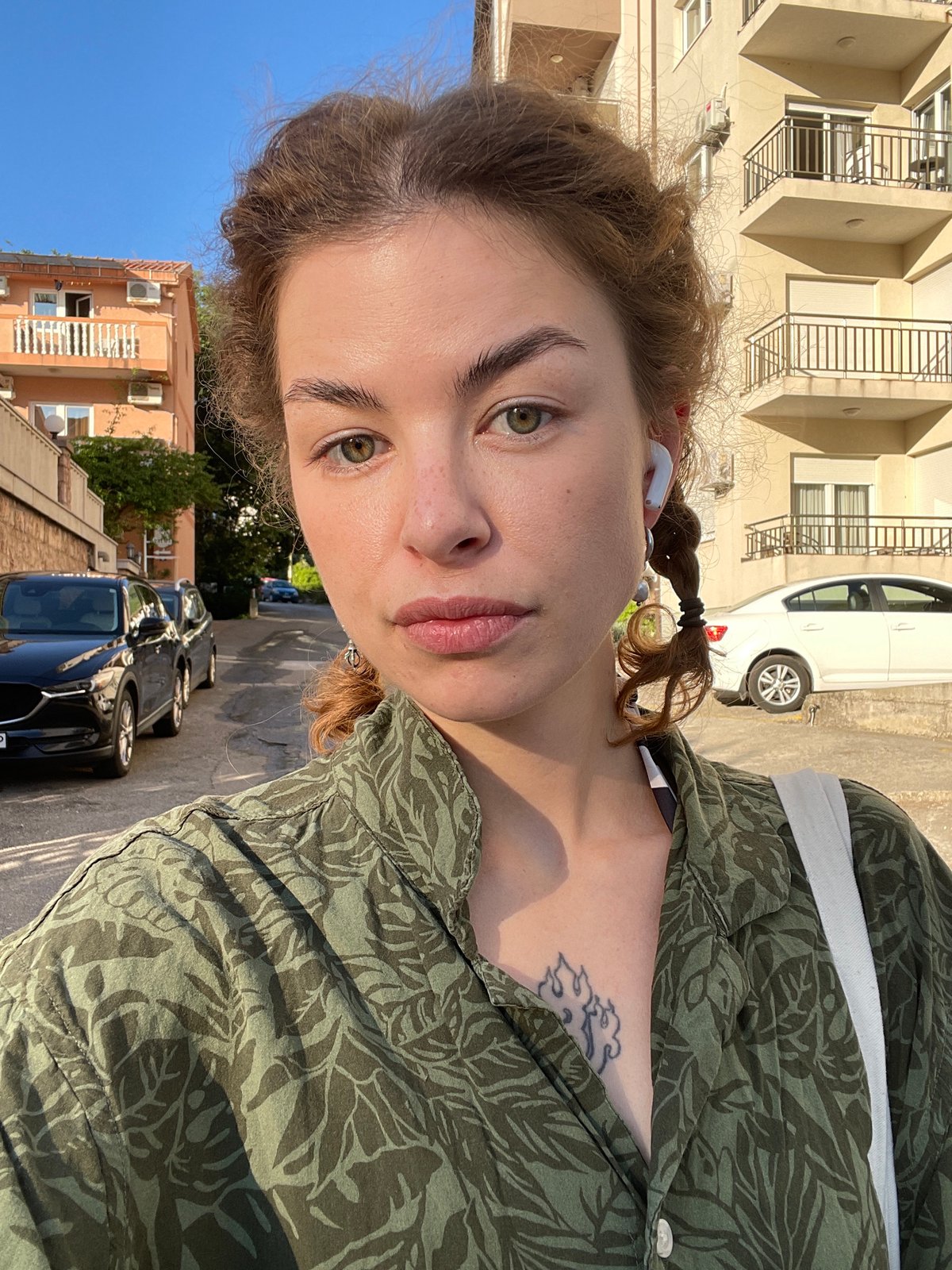 Woman takes selfies on street in Rafailovići, Montenegro