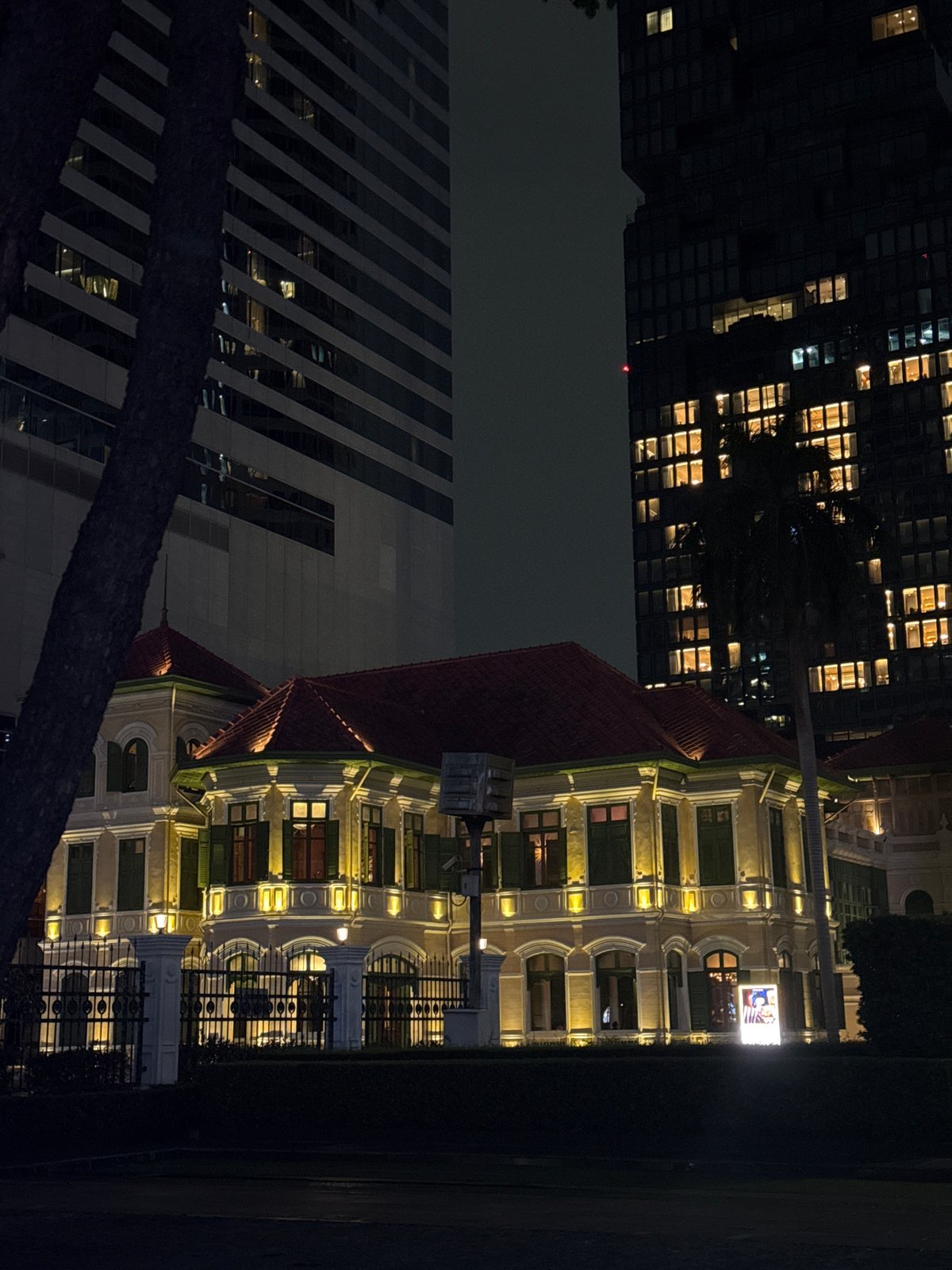 Nighttime Bangkok: colonial facades meet Sathorn skyscrapers