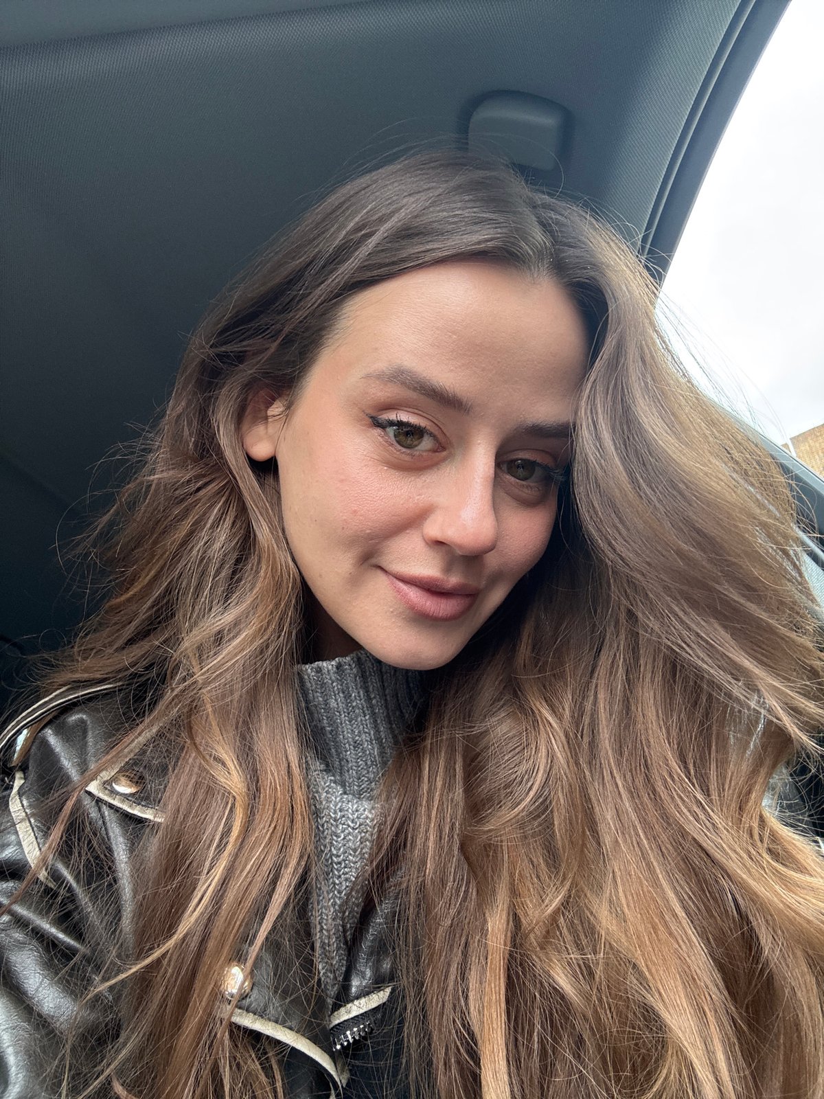 Woman takes selfie in car interior in Krasnoyarsk