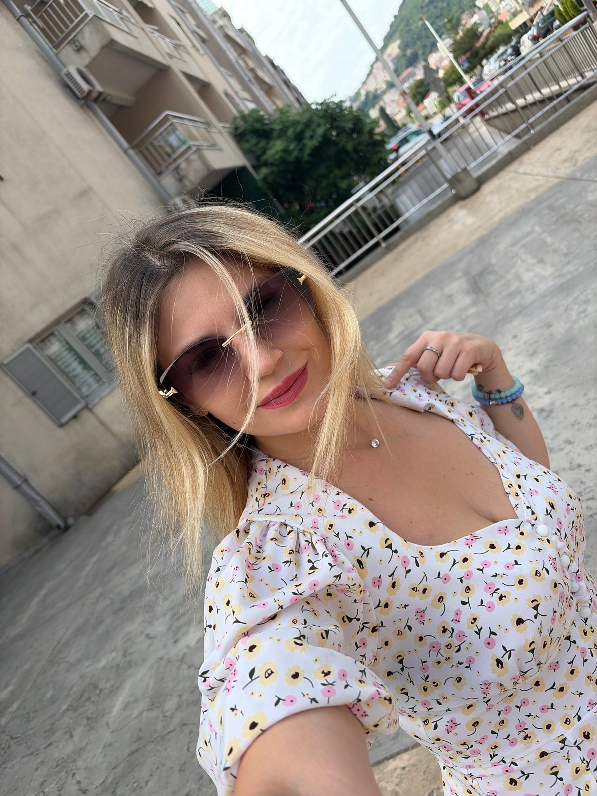 Woman takes selfies in Budva, Montenegro morning