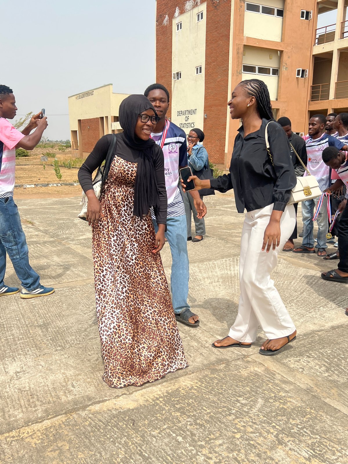 Groups gather, take photos outside Statistics Department in Minna