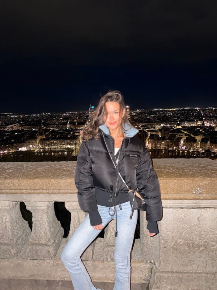 Woman enjoys evening sightseeing and dining in Lyon, France