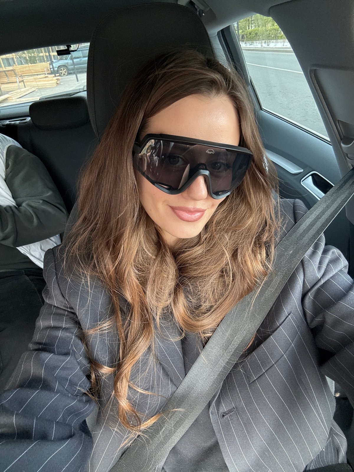 Woman in pinstripe suit observed in car in Krasnoyarsk