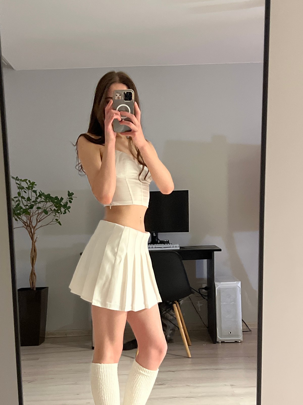 Woman takes mirror selfies in Ternopil bedroom, cat spotted