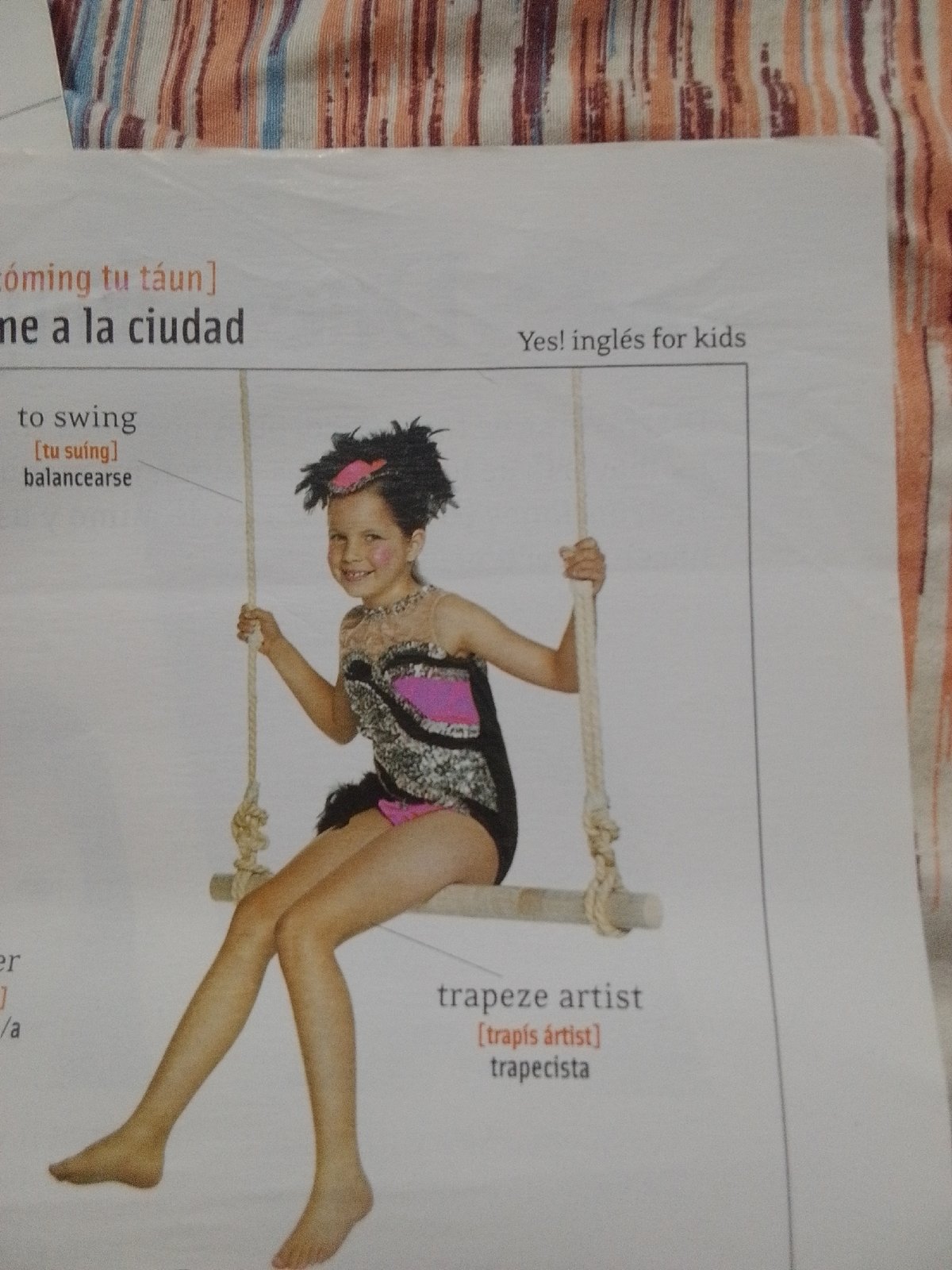 Bilingual English-Spanish learning materials photographed in La Tagua