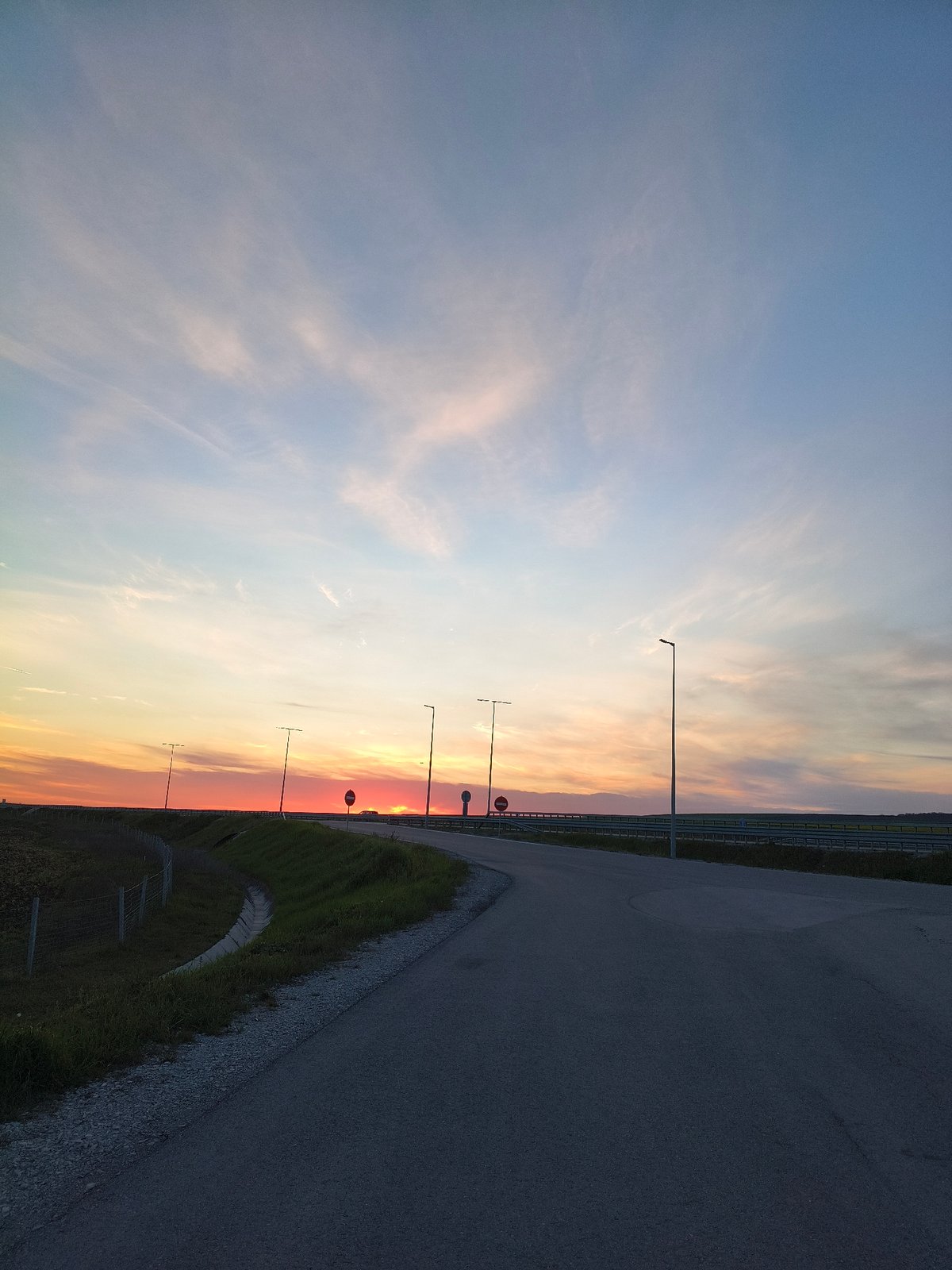 Colorful sunset captured over rural highway in Gradishte, Bulgaria