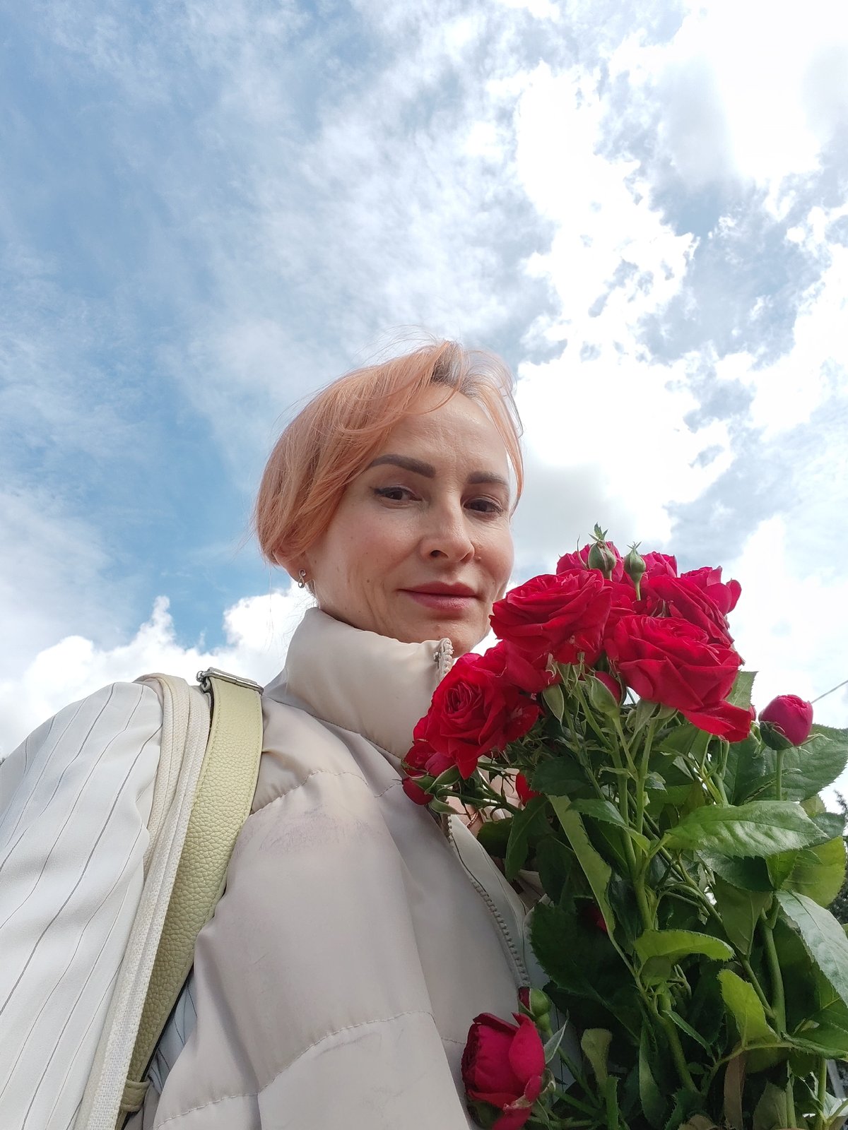 Red roses and selfies on a bright summer morning in Chaikovsky