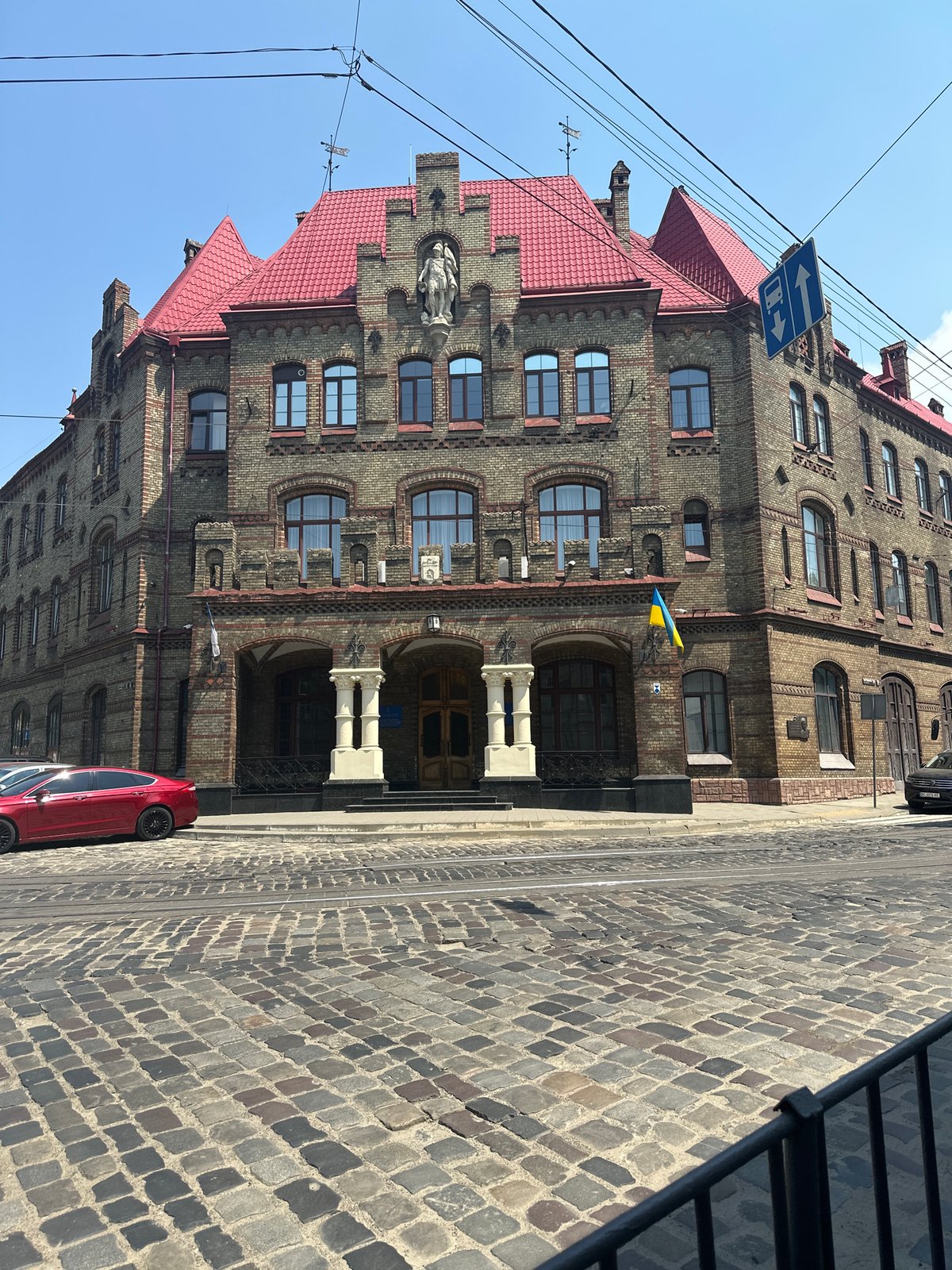 Historic brick building with mansard roof under clear skies