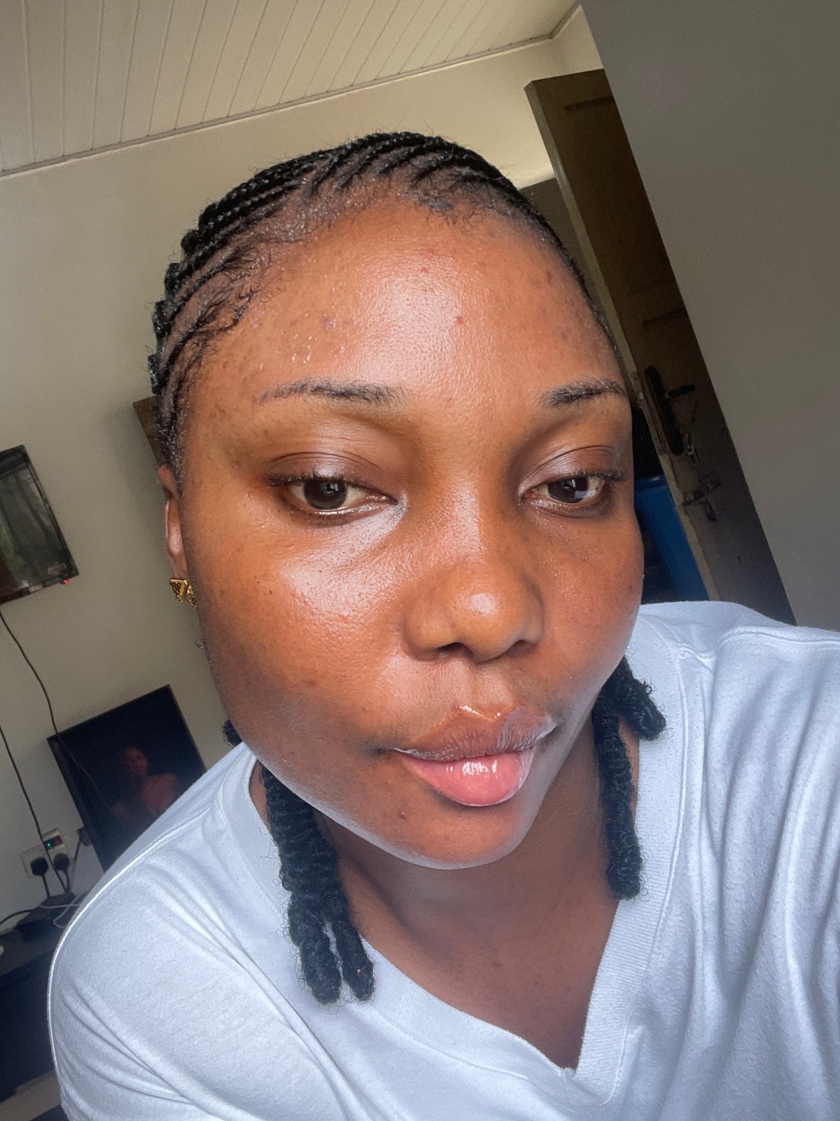Woman takes morning selfies applying makeup in Abuja home