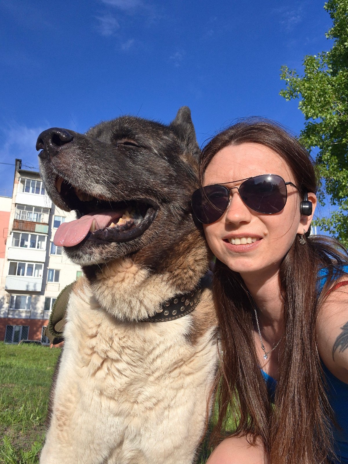 Woman and dog enjoy sunny afternoon in Russian neighborhood