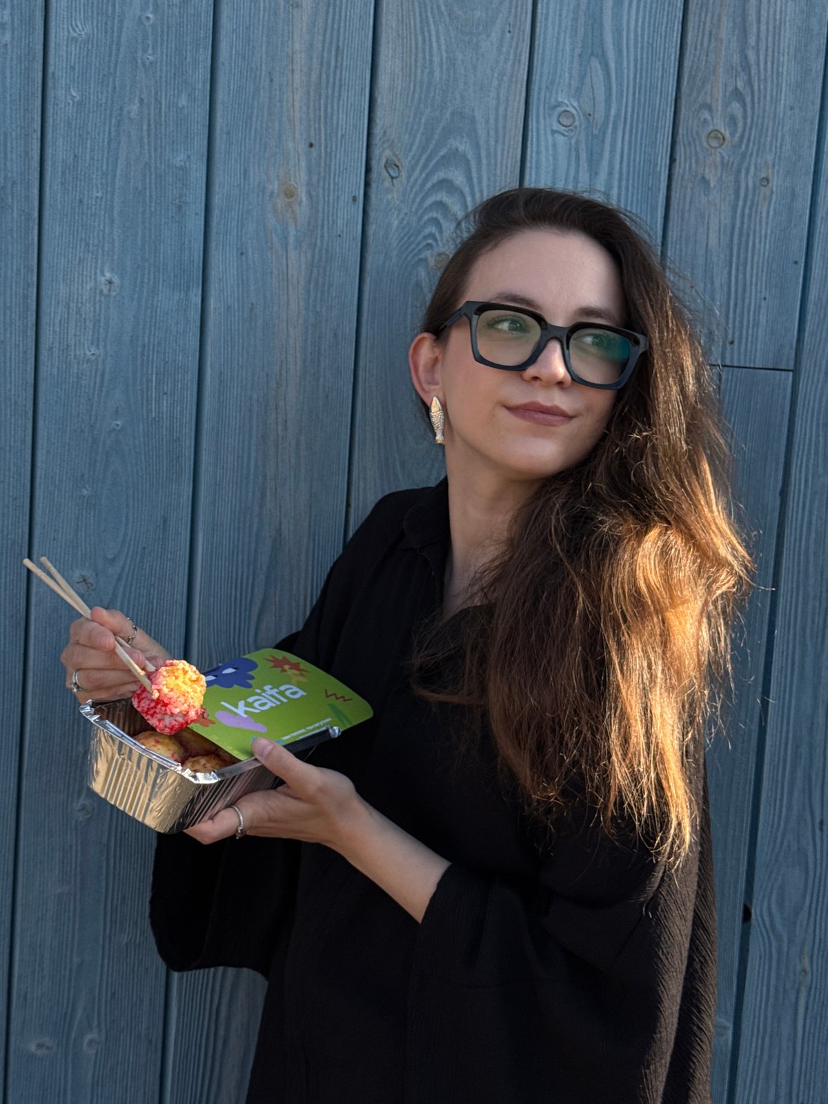 Woman enjoys sushi lunch during waterfront visit in Chaikovsky
