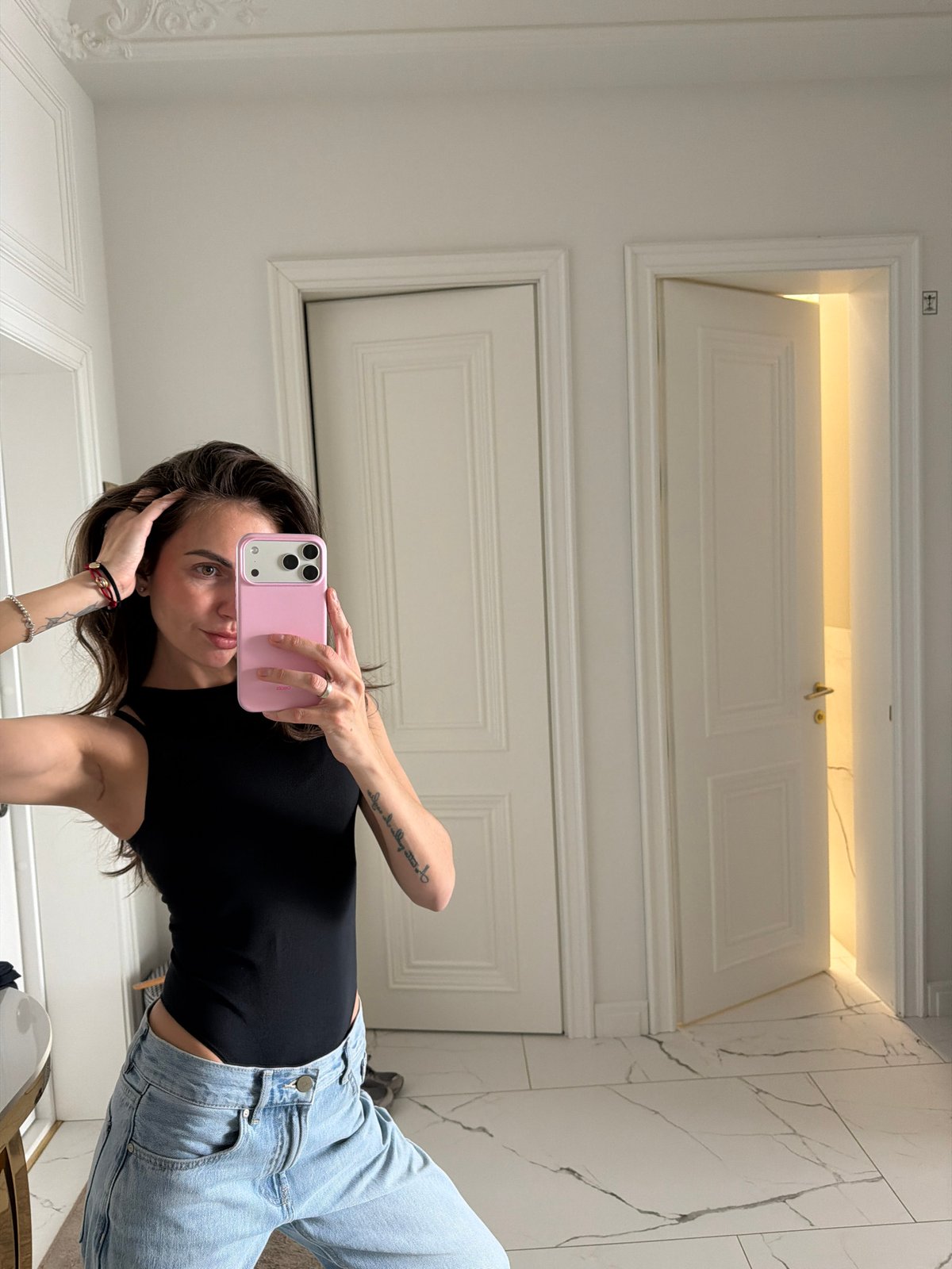 Woman takes mirror selfie with pink phone in Krasnoyarsk