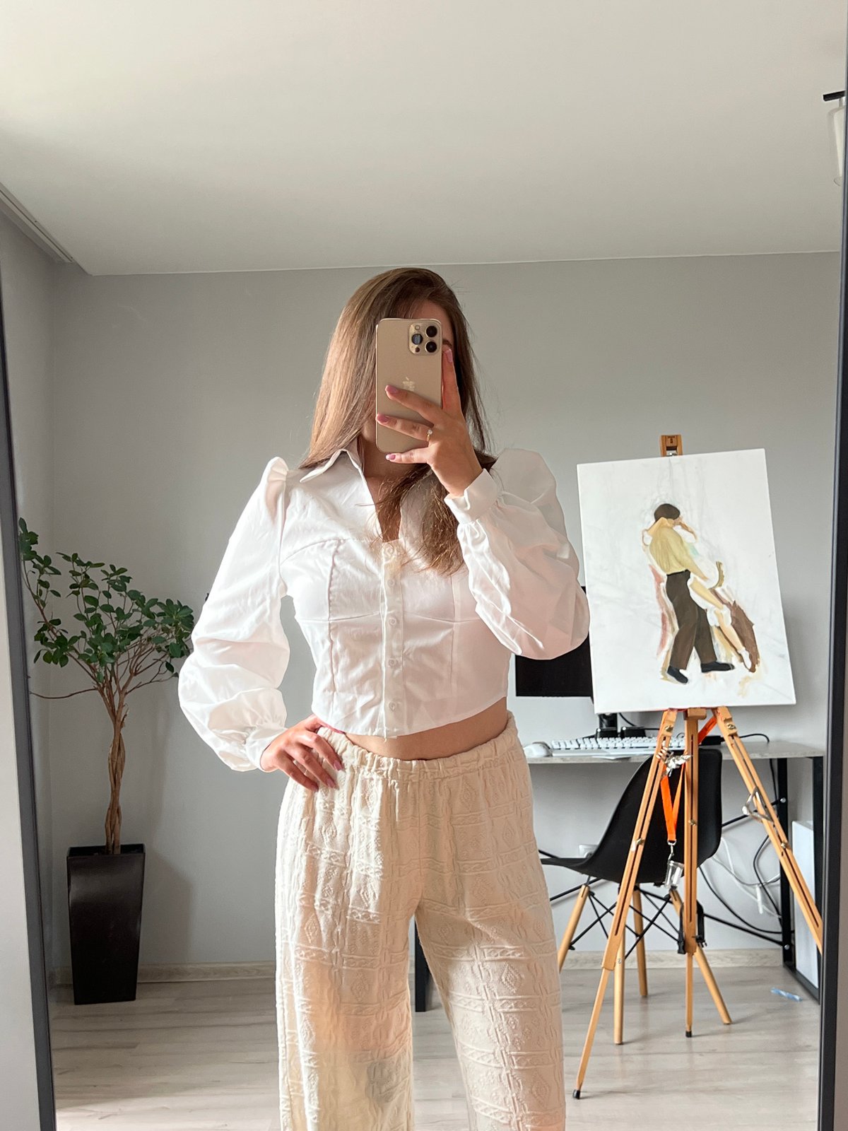 Mirror selfie session in a Ternopil room, white puff-sleeve outfit