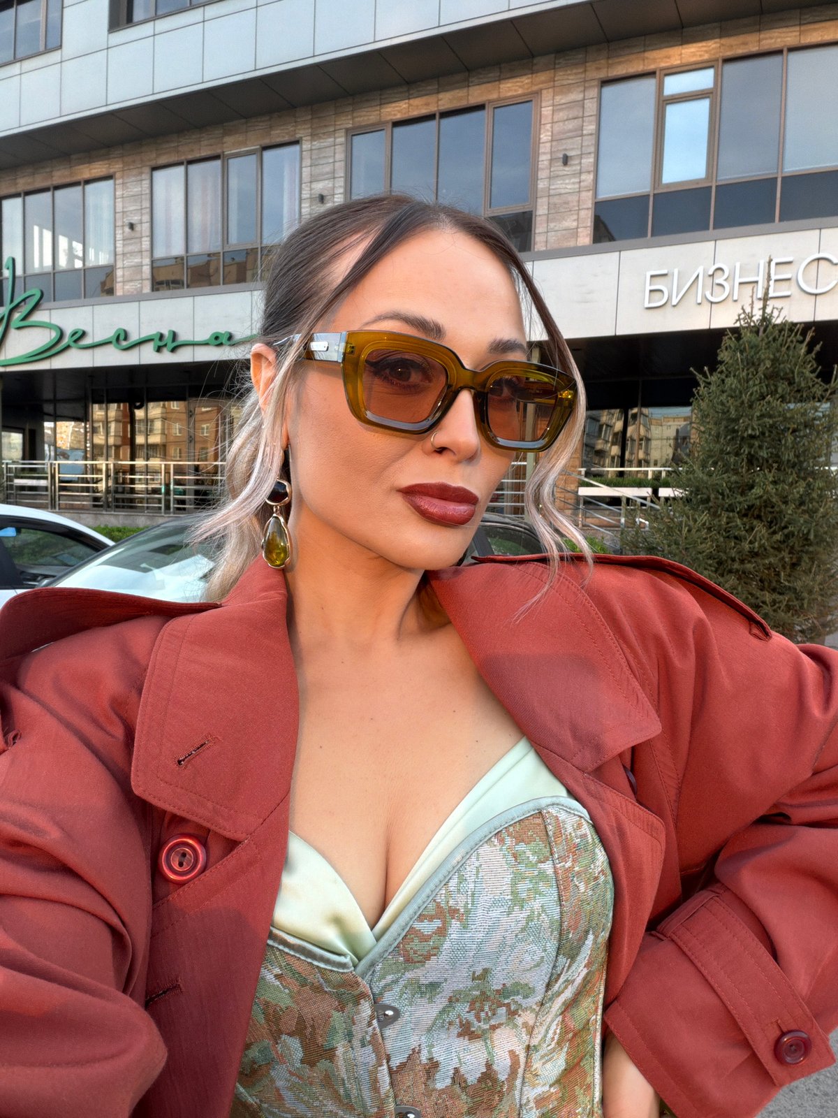 Woman poses for photo outside business building in Krasnoyarsk