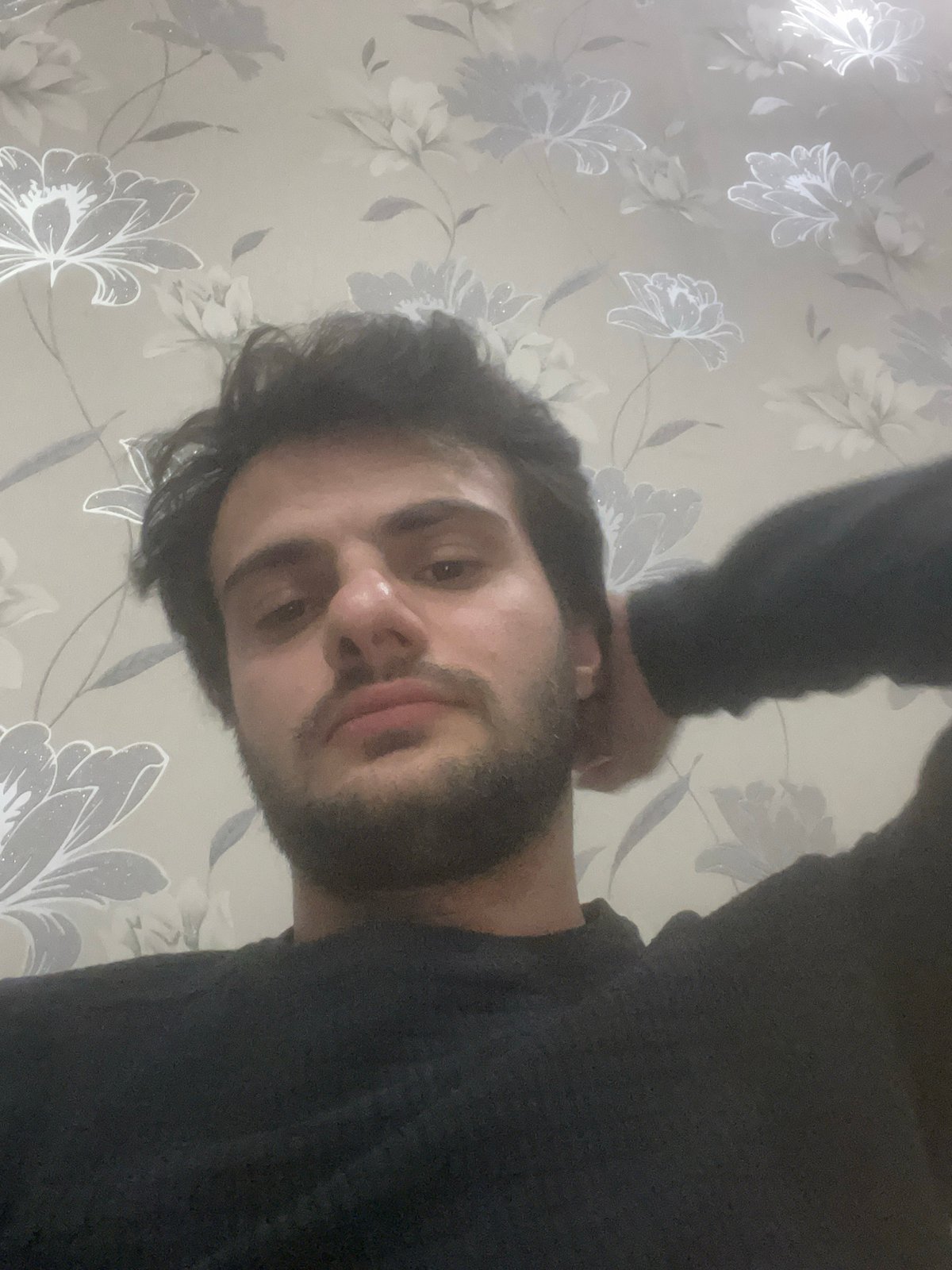 Man photographed multiple times in Tbilisi indoor setting