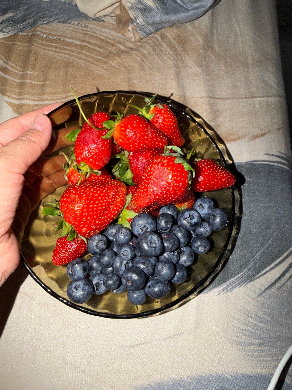 Moscow resident enjoys fresh berries from glass bowl