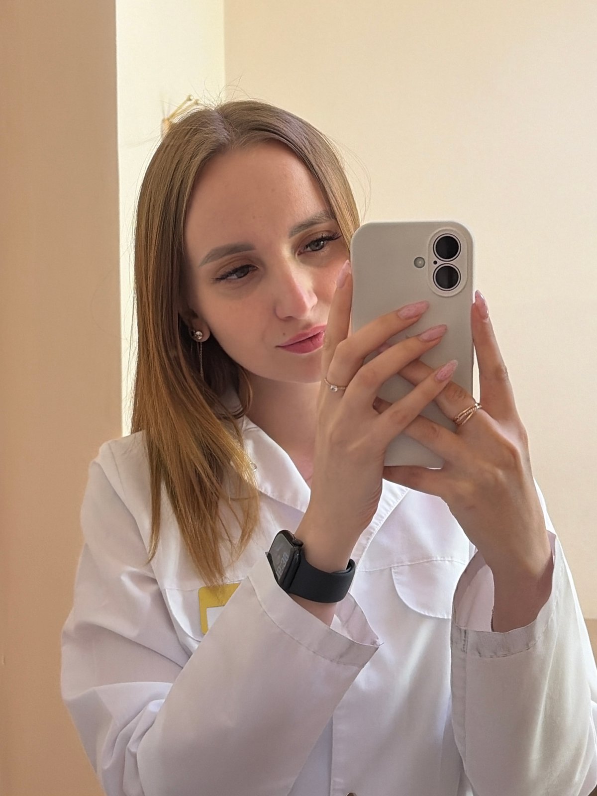 Woman in lab coat takes selfie in Chaikovsky, Russia