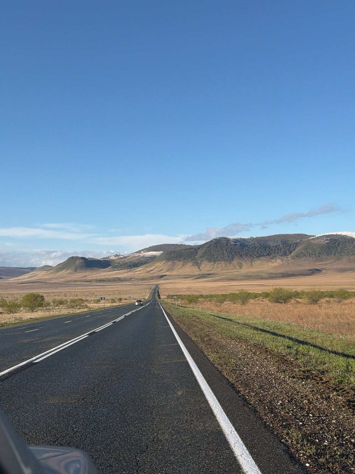 Vehicle travels rural highway near Bazandaikha, Russia