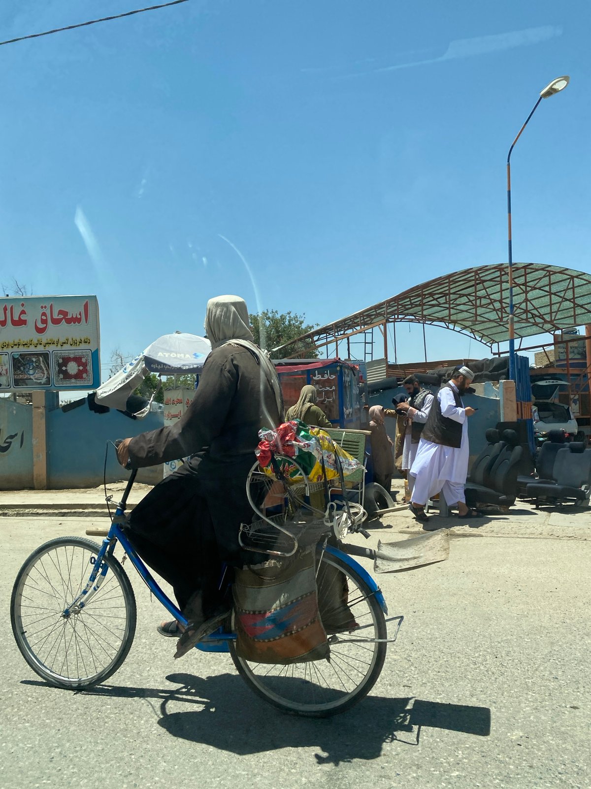 Cycling through a sunny Kandahar street