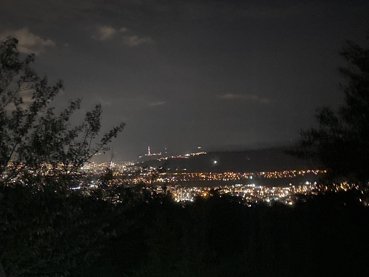 Evening gathering at Tbilisi cemetery overlooks illuminated city