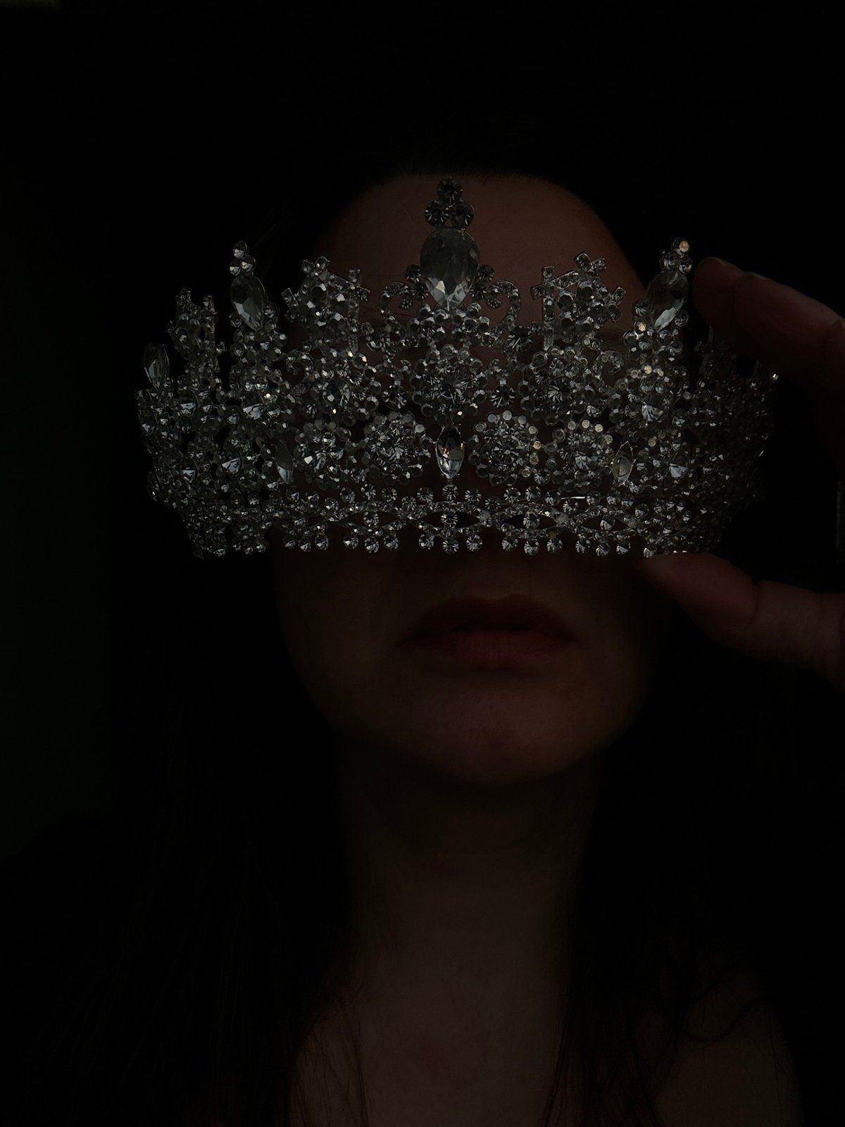 Woman in ornate crown photographed multiple times in Riga