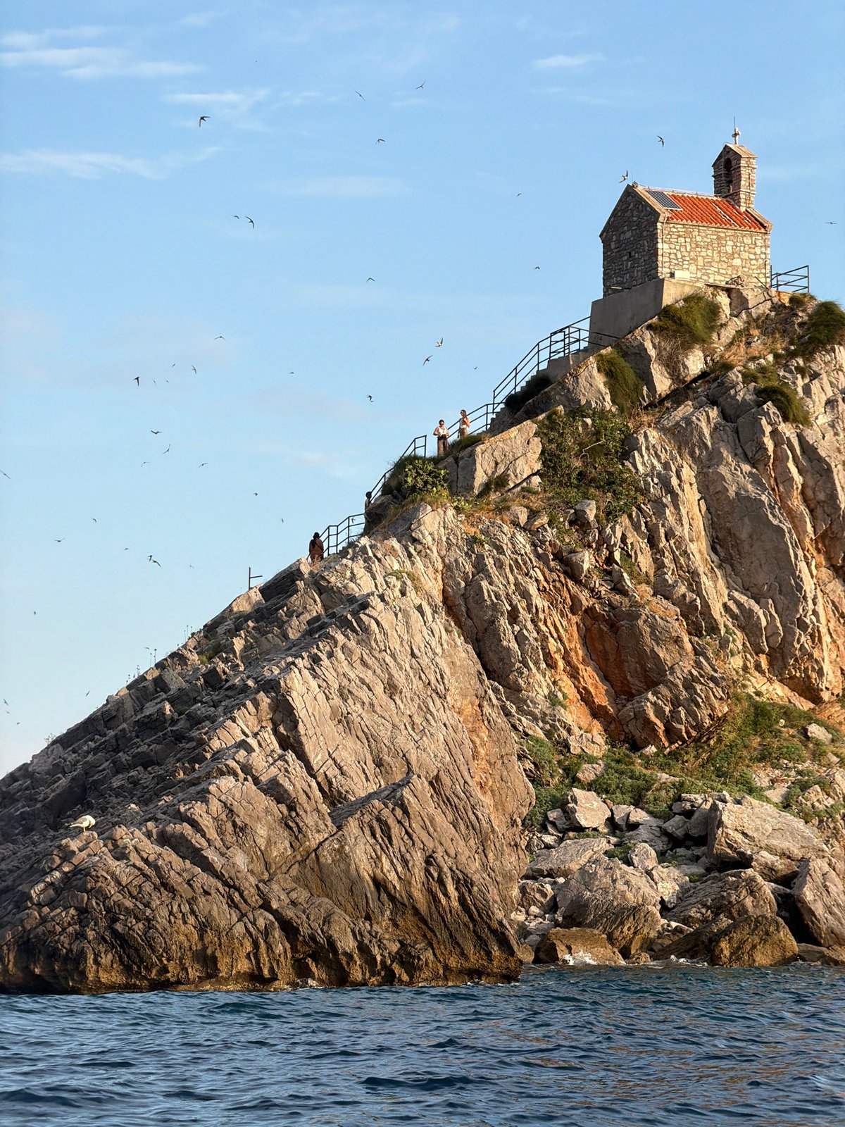 Summer afternoon on Petrovac's pebble beach and Adriatic bay