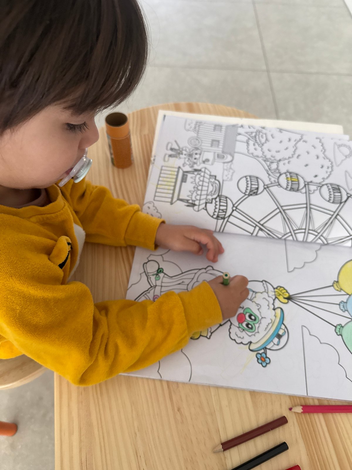Child colors carnival-themed book in Luxembourg Saturday morning