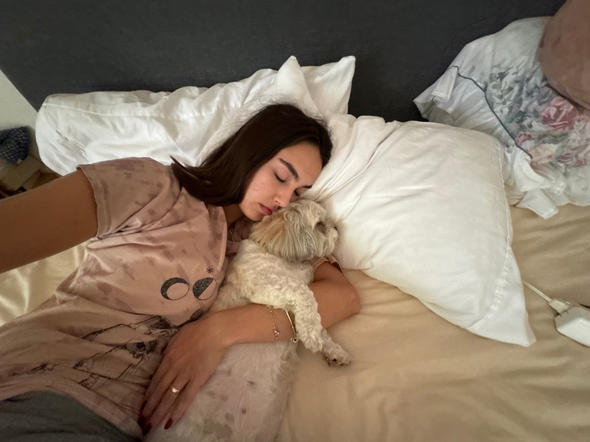 Woman and small white dog share quiet moment in Mexico City