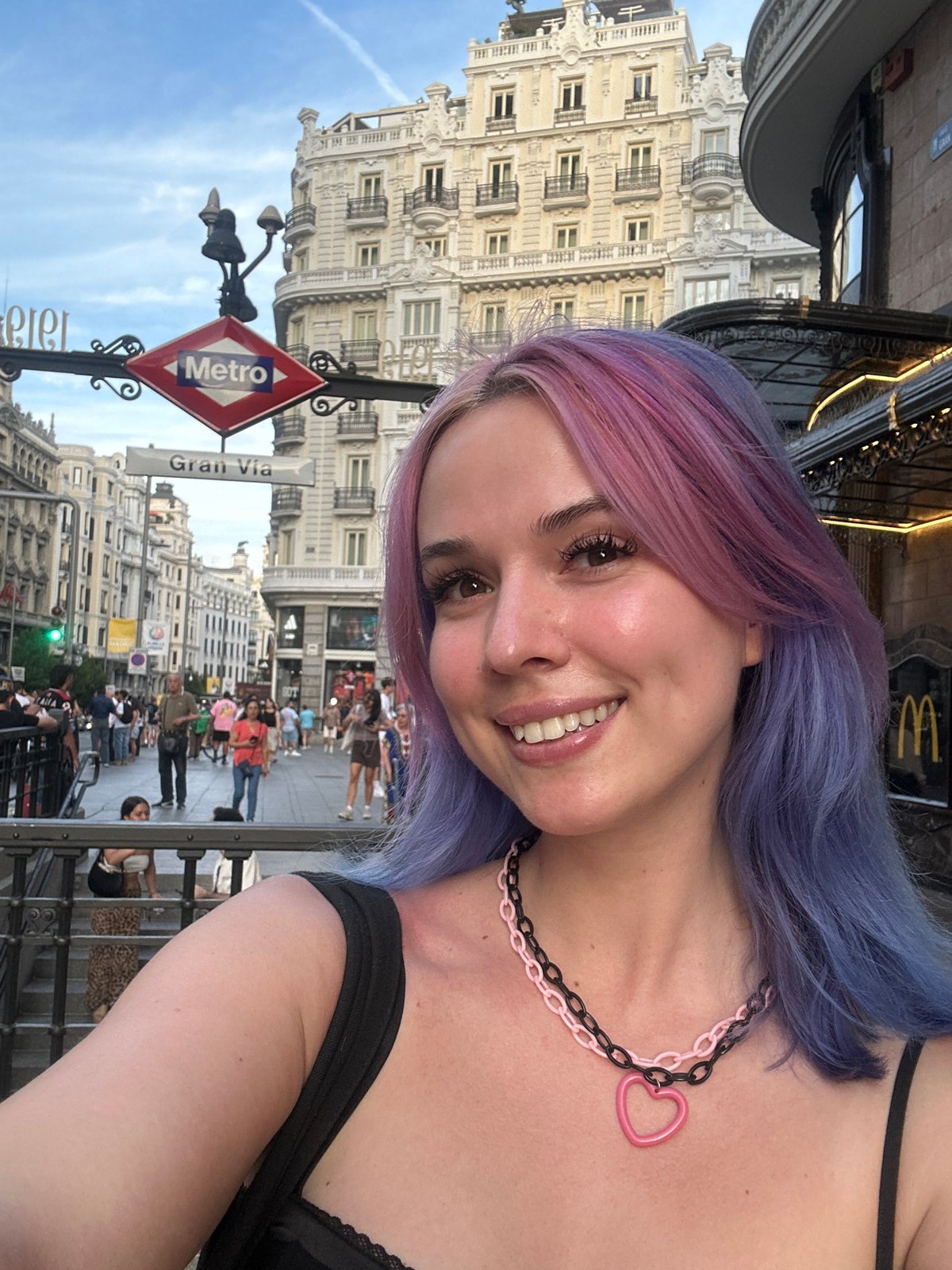 Tourist documents evening stroll through Madrid's historic Gran Vía district