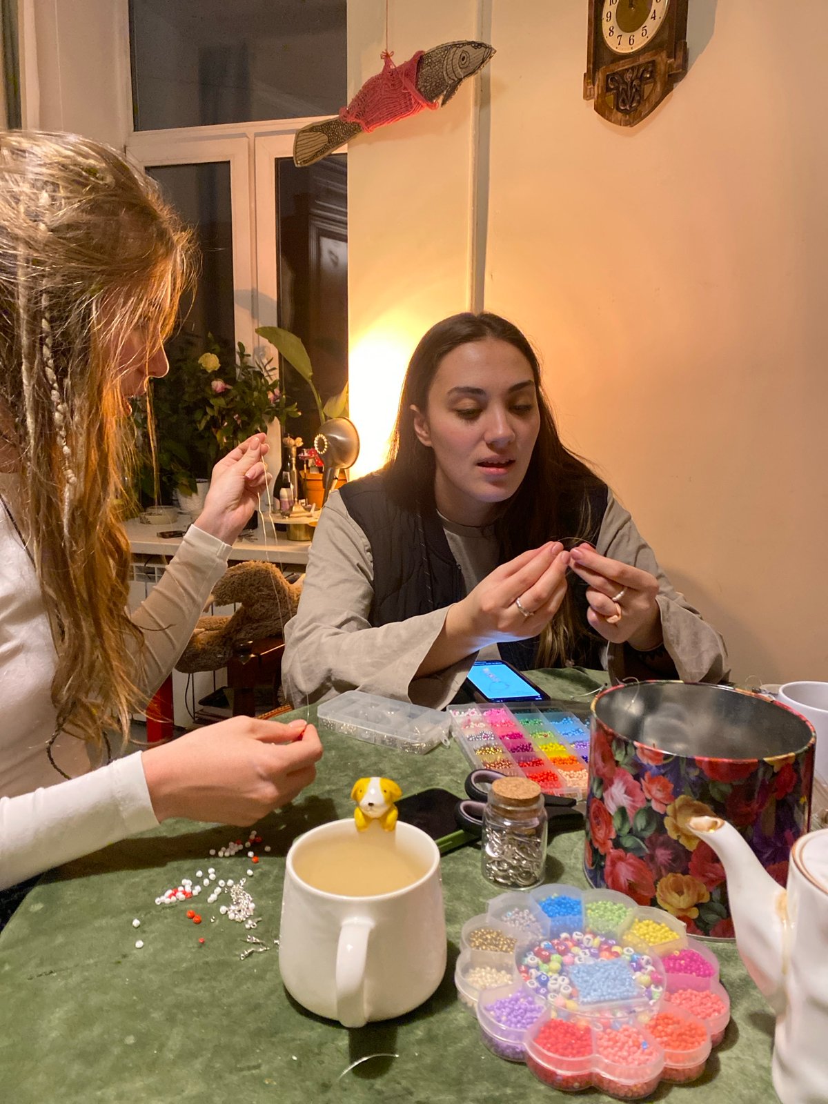 Two women craft beaded jewelry in Moscow