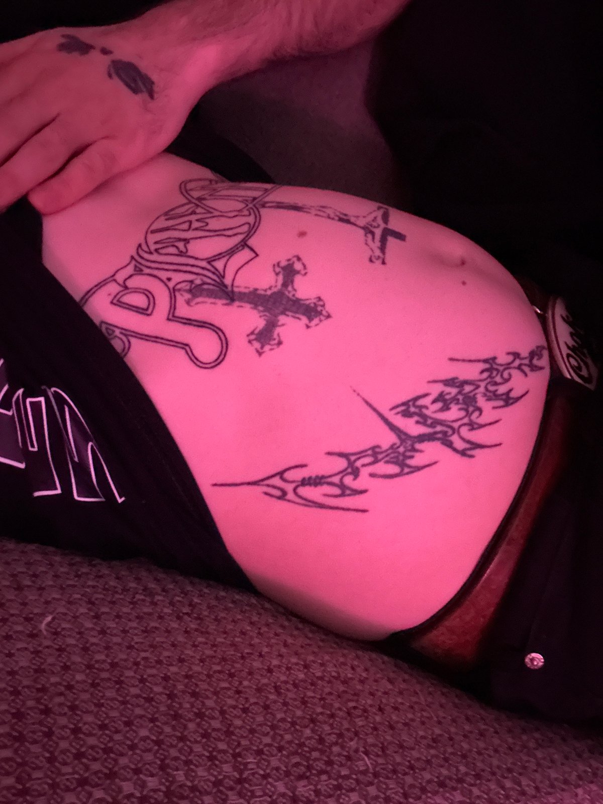 Person photographed reclining indoors under pink lighting in Buenos Aires