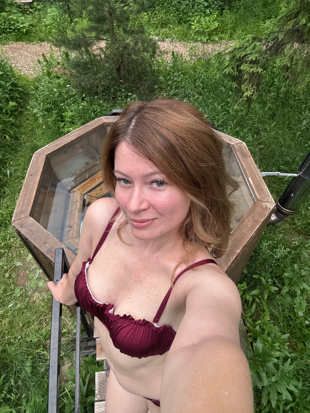 Women enjoy hot tub facility in Russian forest setting
