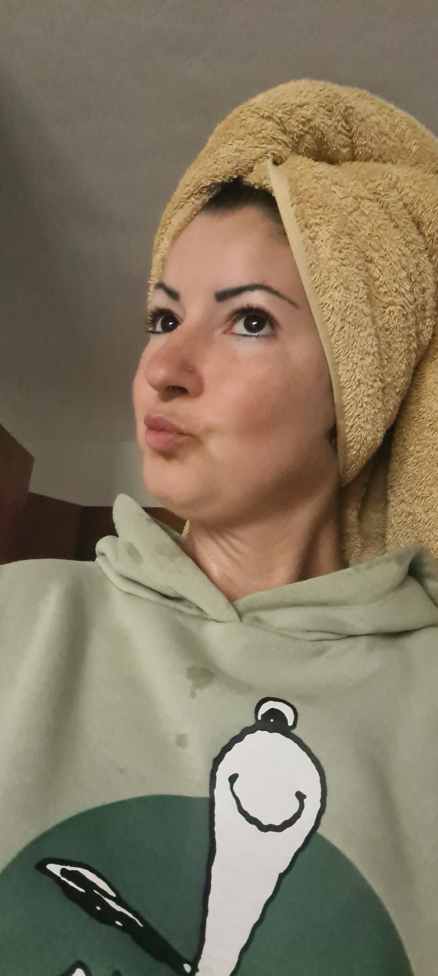 Woman applies skincare during morning routine in Nahariyya
