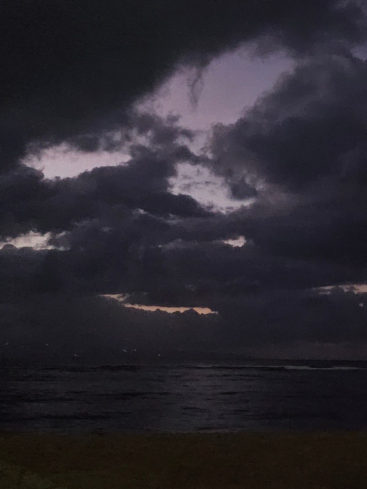 Storm clouds gather over Denpasar beaches at dusk