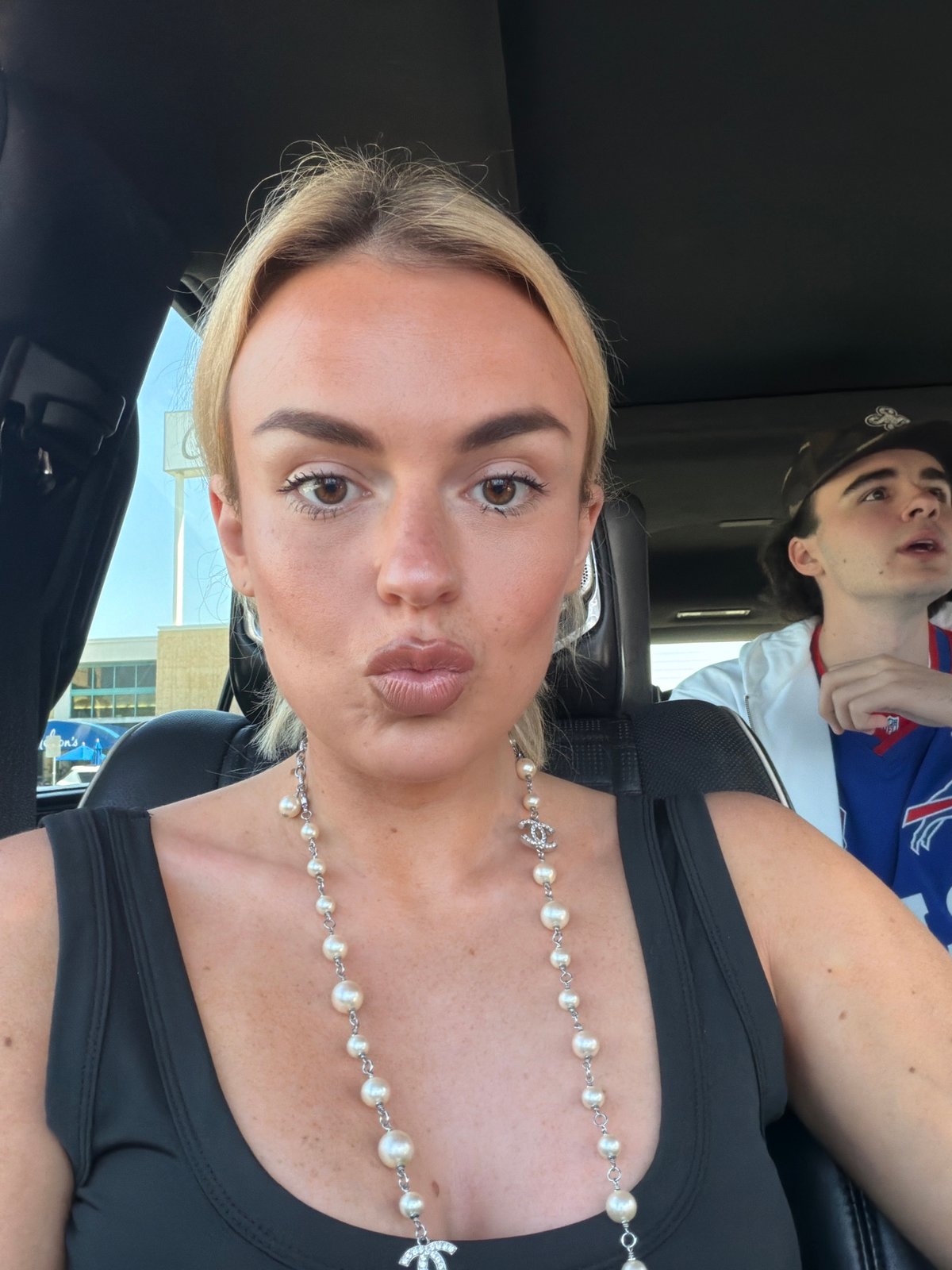 Woman takes selfie in car during evening in Los Angeles