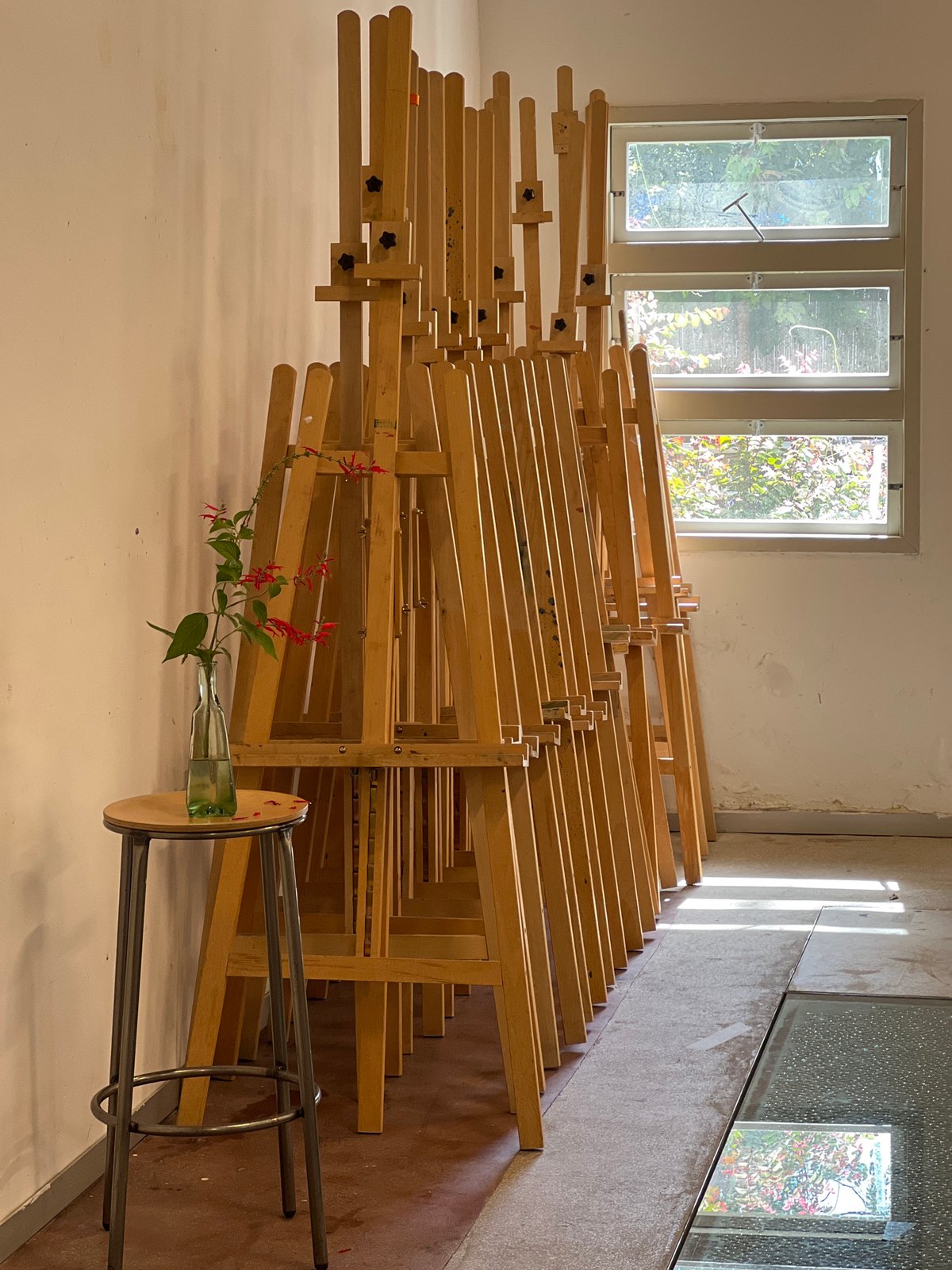 Art studio with stacked easels documented in Tel Aviv